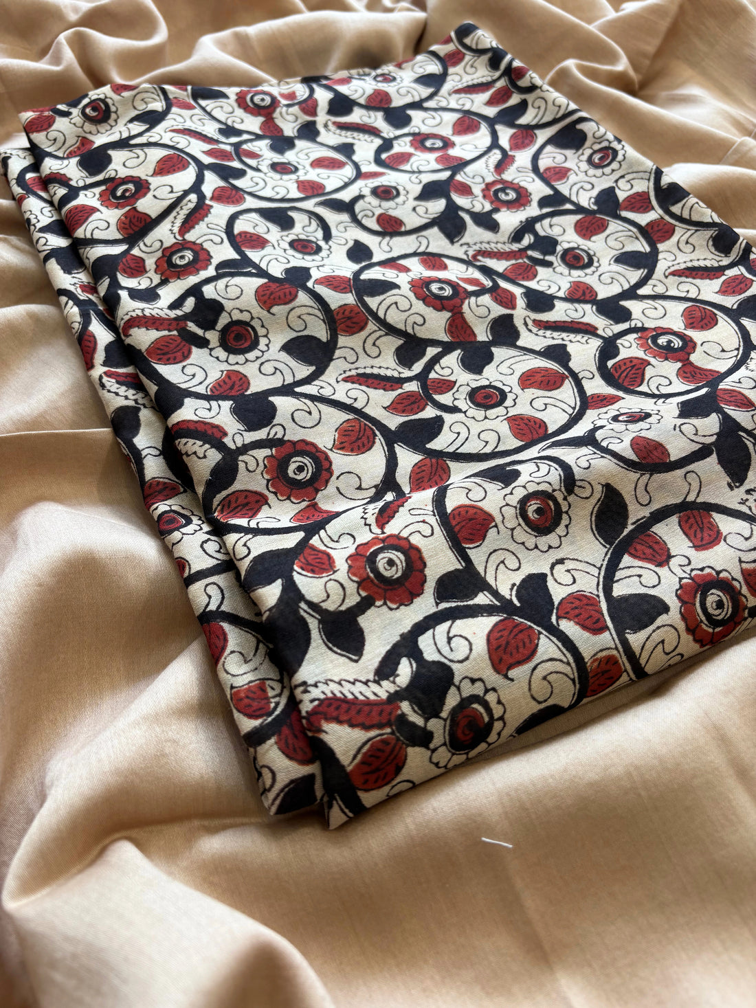 Maheshwari fabric suit with Kalamkari floral print in black, ivory, and maroon tones, featuring traditional hand-block designs and striped dupatta.