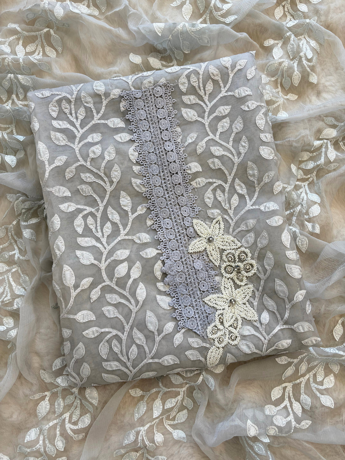 Silver grey organza suit with applique embroidery and moti bead embellishments, paired with embroidered organza dupatta.
