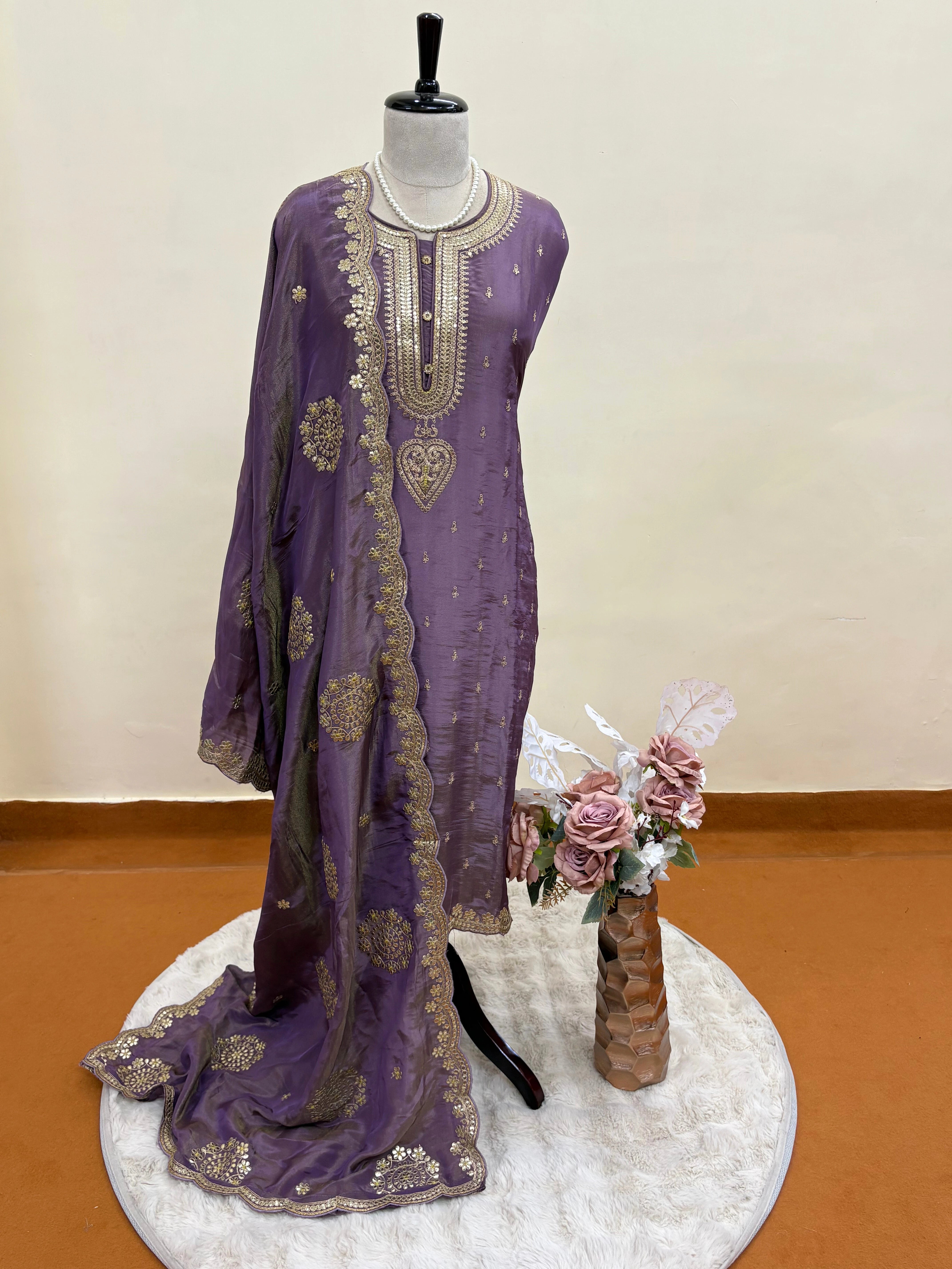 Royal purple silk unstitched suit with golden zari embroidery, sequins, floral motifs, and embroidered dupatta – perfect for weddings and festive wear
