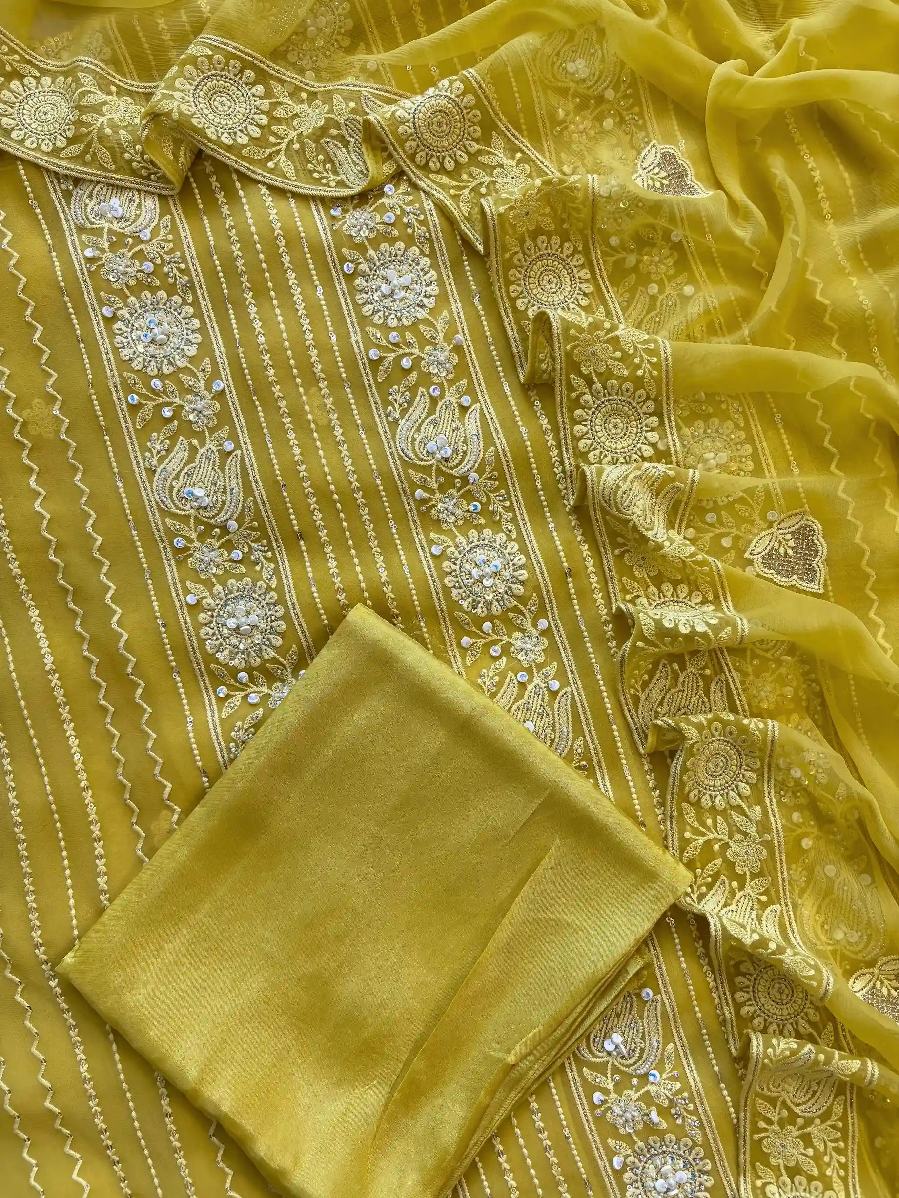 yellow georgette chikankari unstitched suit with moti and sequence embellishments