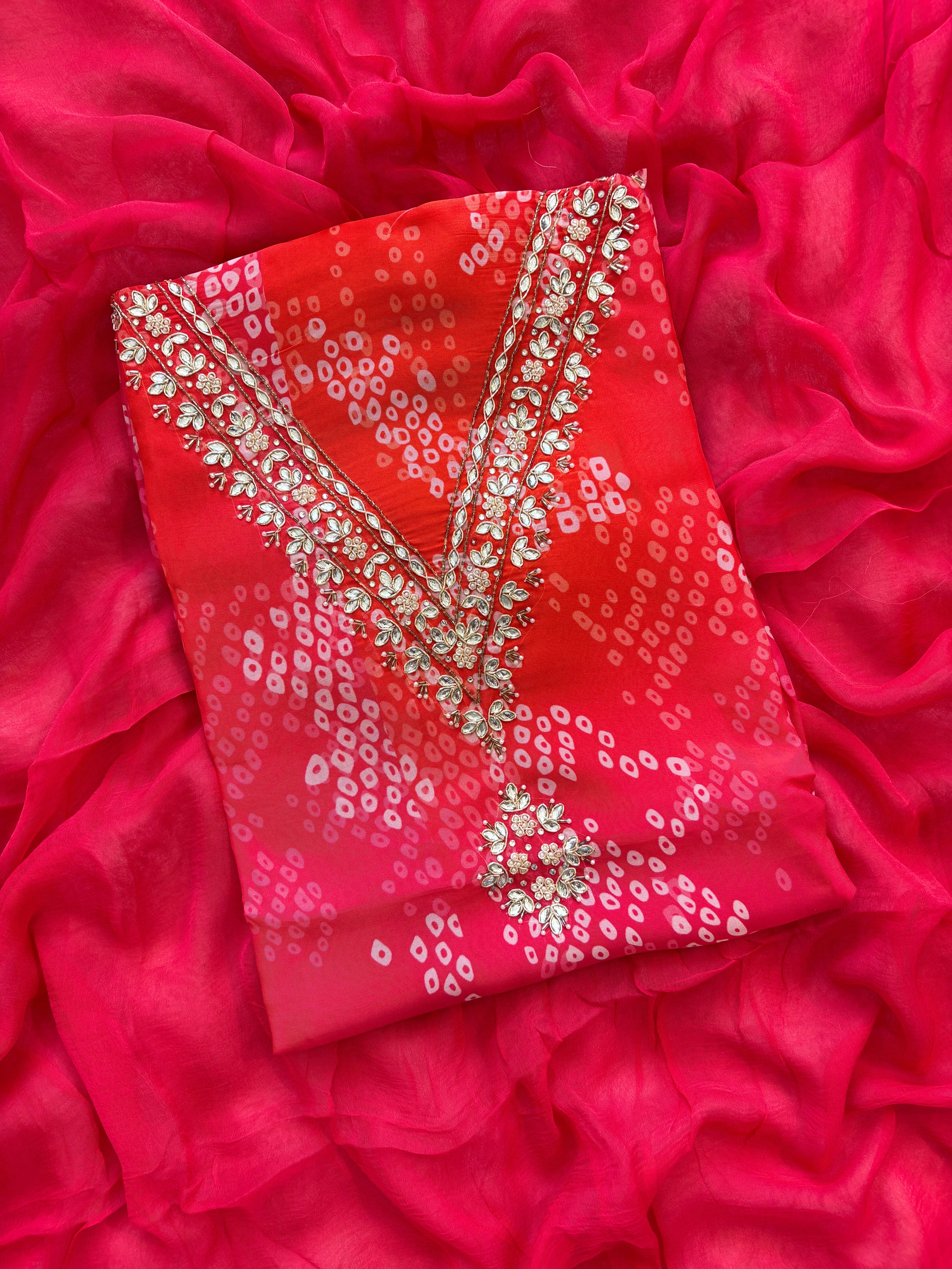 Red organza bandhani suit with ombre effect and chiffon dupatta with lace border.