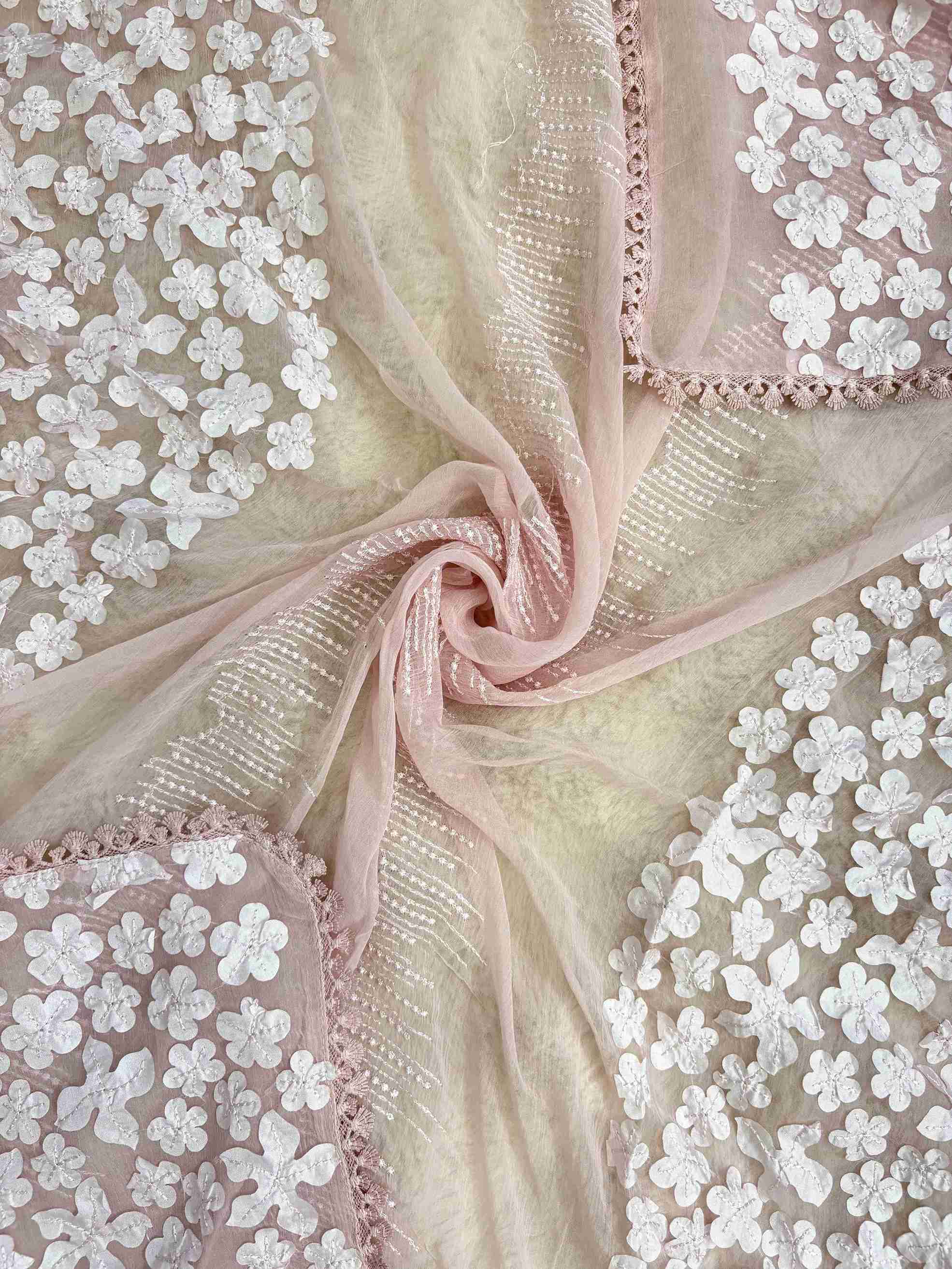 White floral applique on longer sides and four-sided lace finishing on baby pink chiffon dupatta