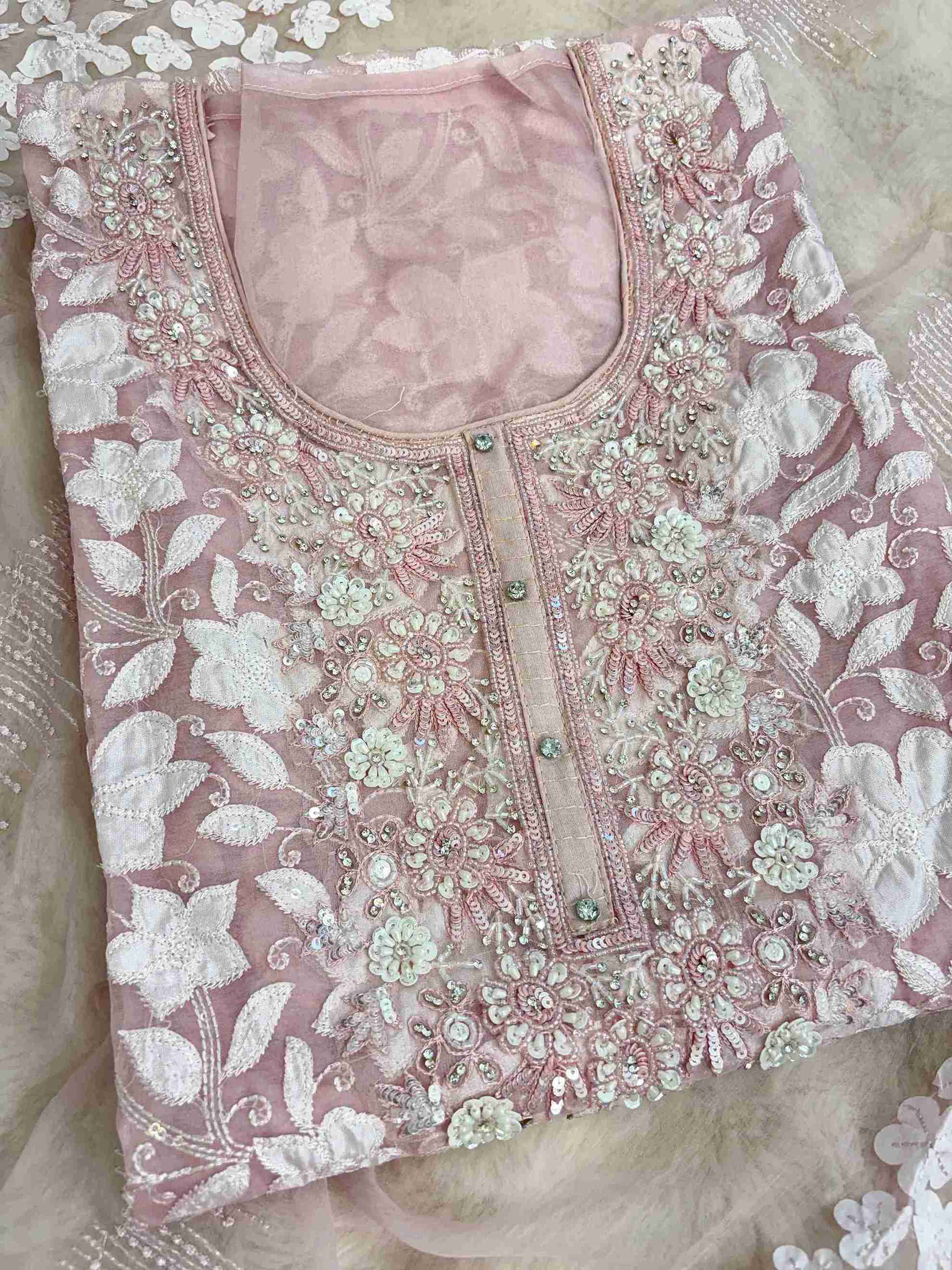 Heavily embellished sequin, moti, and bead neckline detail on baby pink organza unstitched shirt
