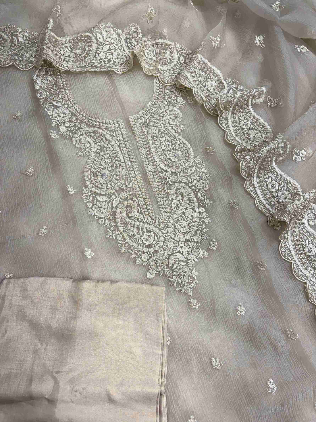 Complete beige marble chiffon unstitched suit flat lay set with shirt, dupatta, and opada silk bottom