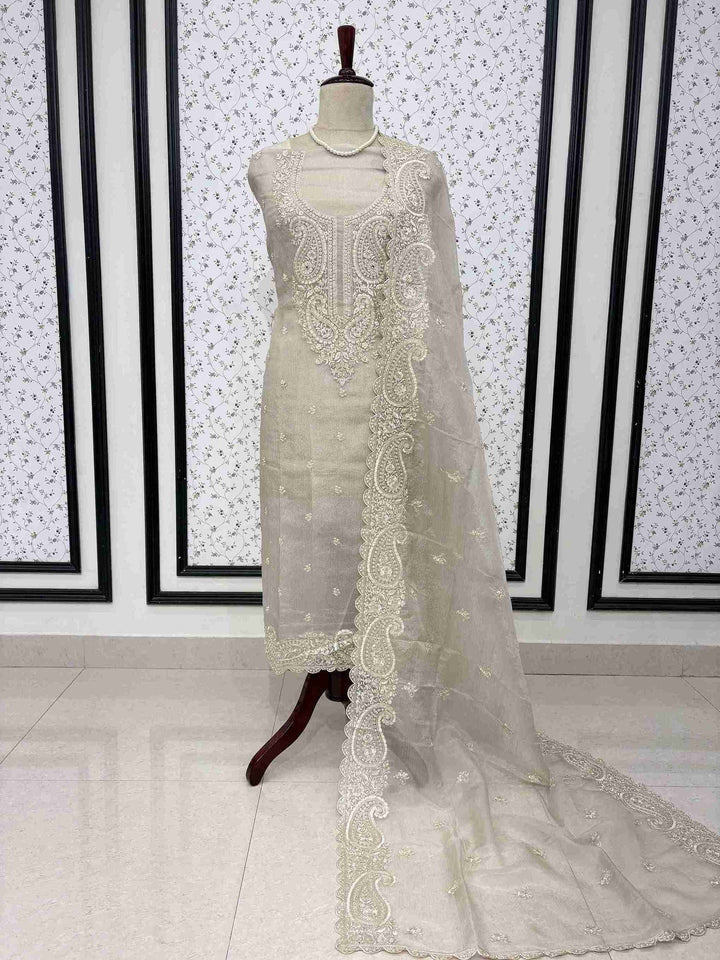 Beige marble chiffon unstitched suit full front view with paisley cutwork dupatta draped on mannequin