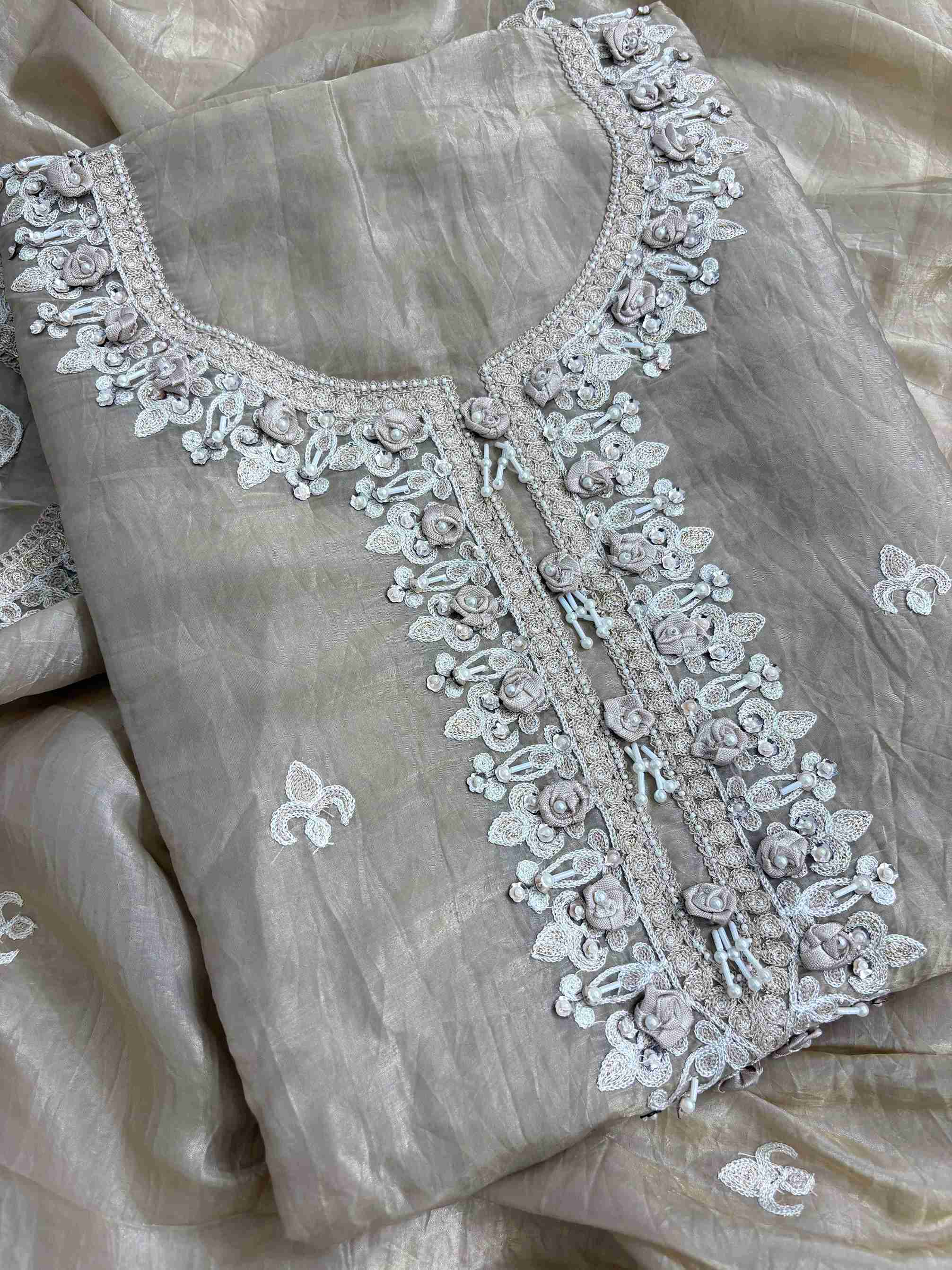 Detailed neckline with pearl thread and 3D floral work on tissue suit