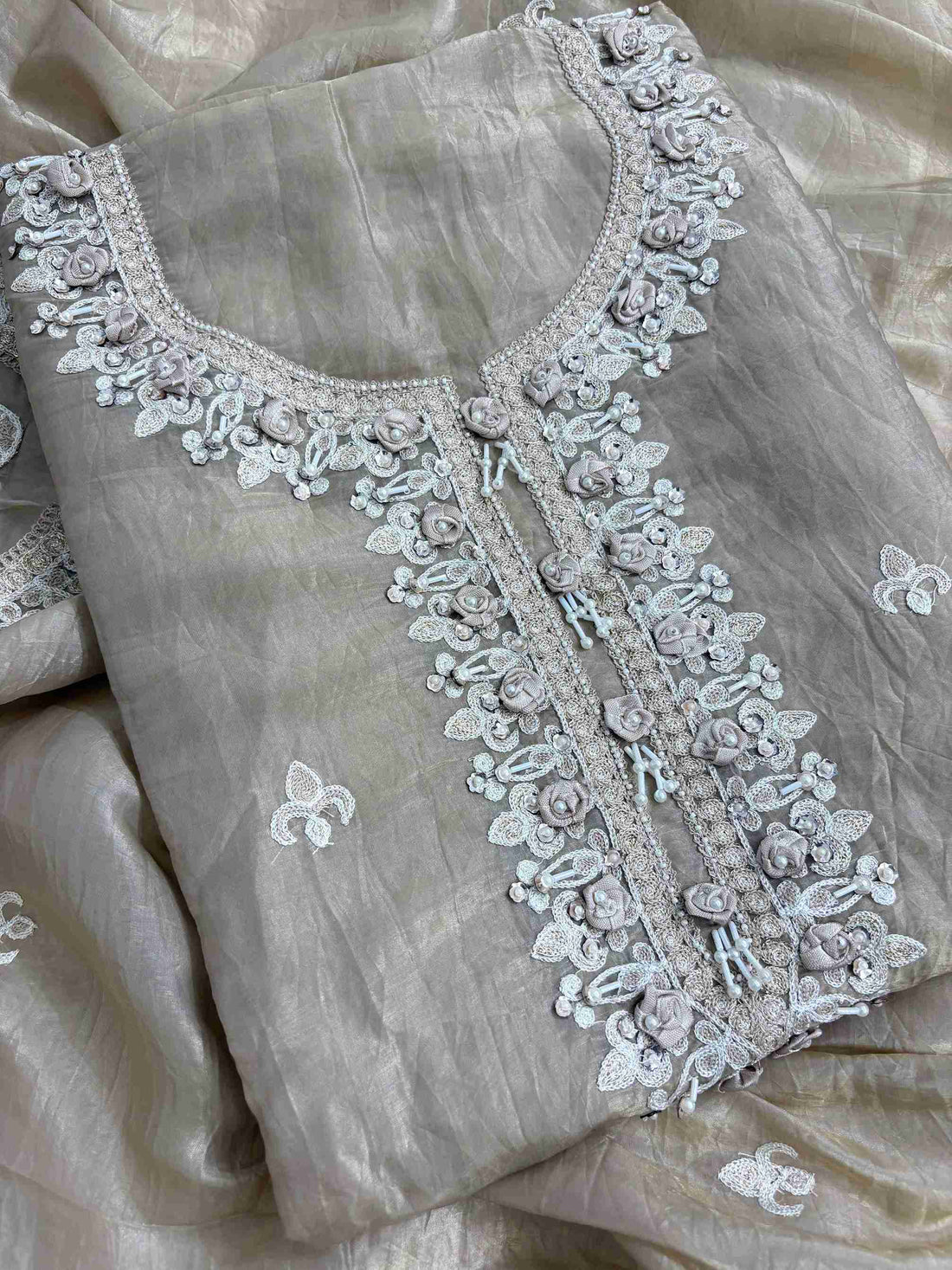 Detailed neckline with pearl thread and 3D floral work on tissue suit