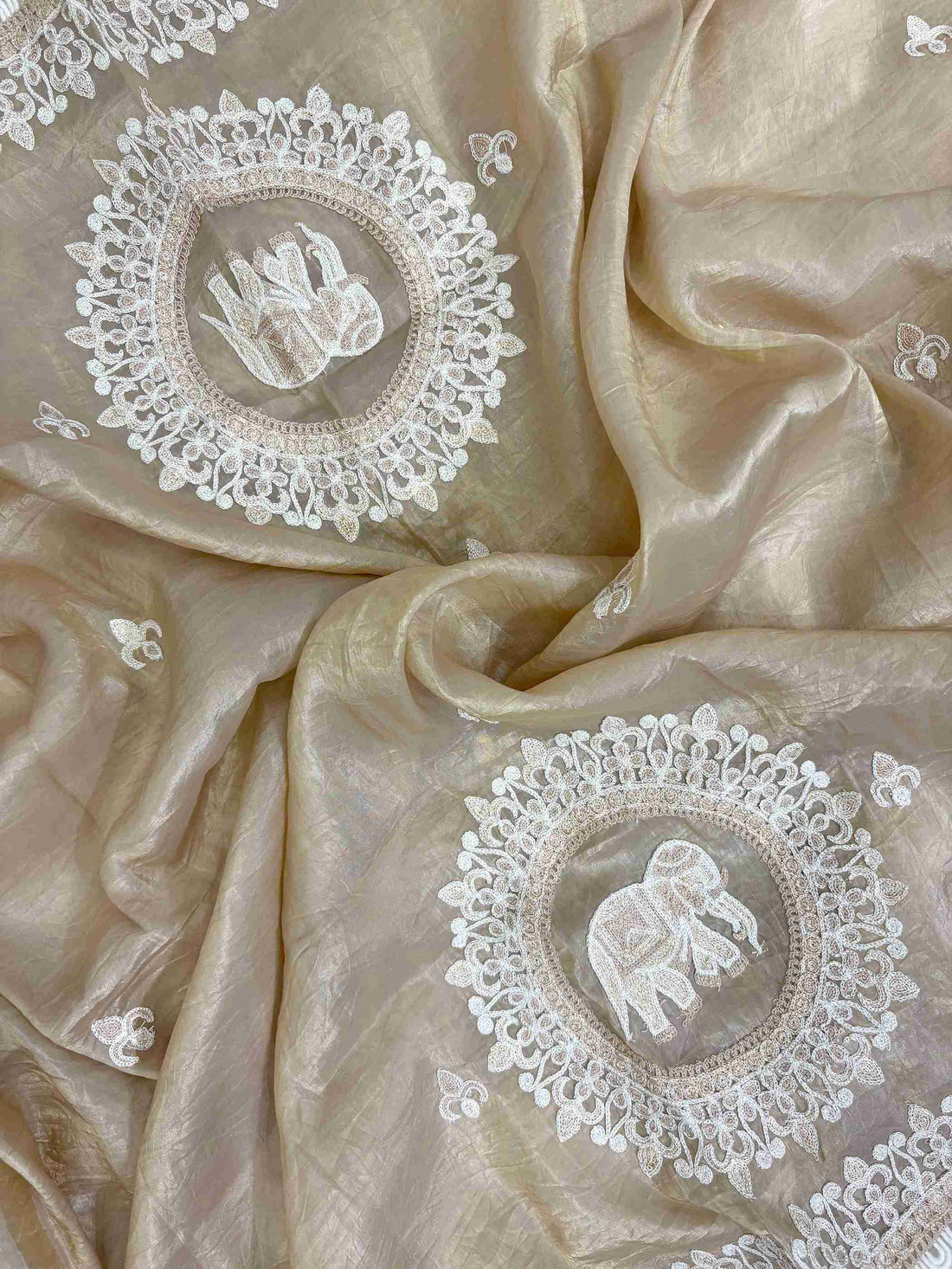 Close view of pearl thread and 3D floral embellishments on tissue fabric