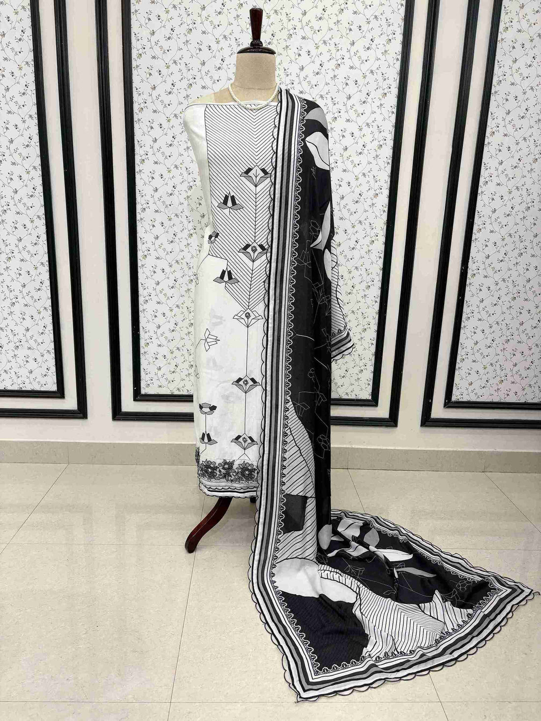 Black and white pure muslin digital print unstitched suit set displayed on mannequin with embroidered organza border dupatta