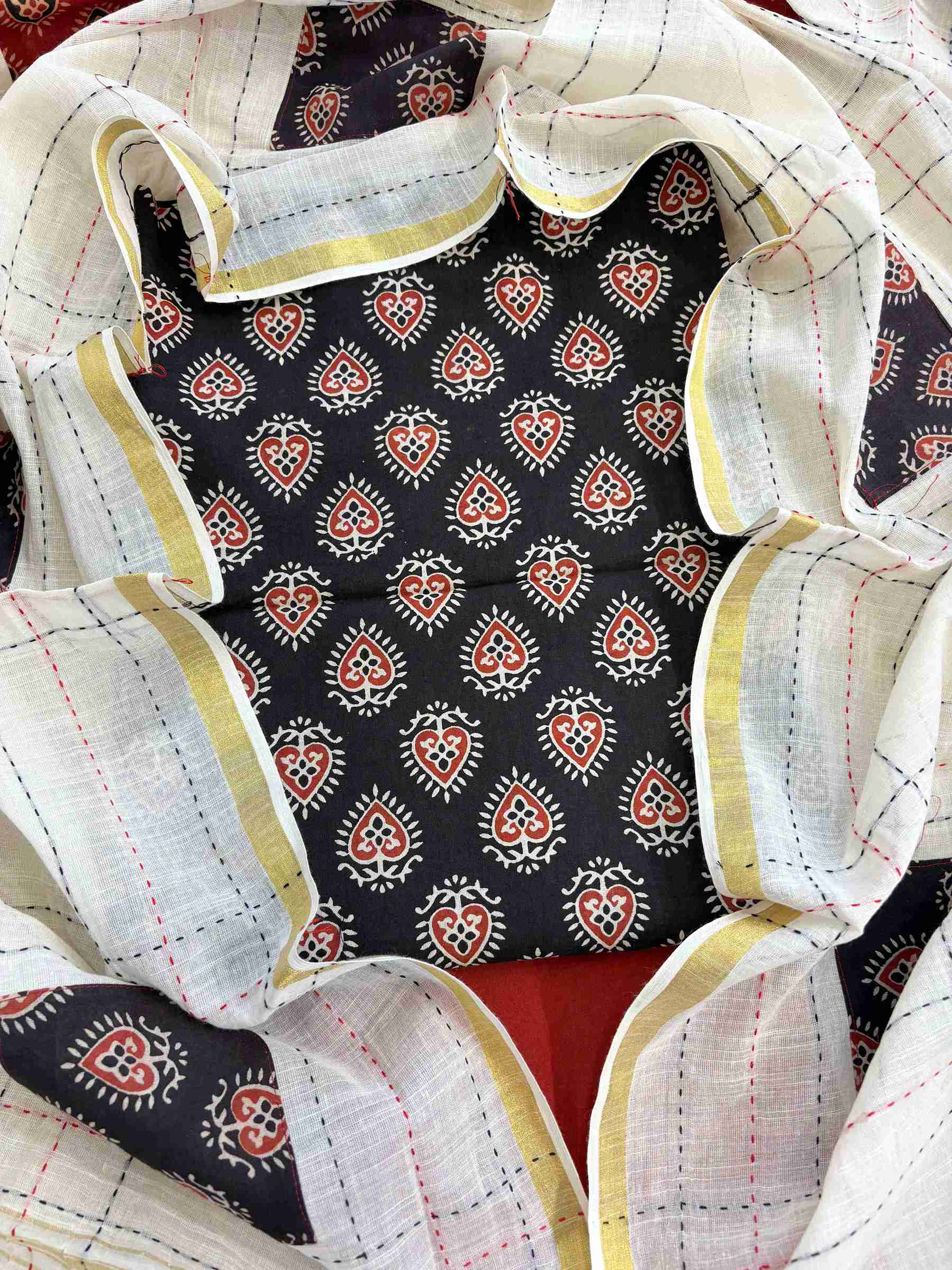 Close-up of black handblock printed cotton kurta fabric with ethnic motifs