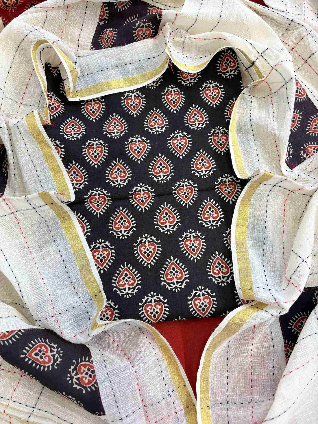 Close-up of black handblock printed cotton kurta fabric with ethnic motifs