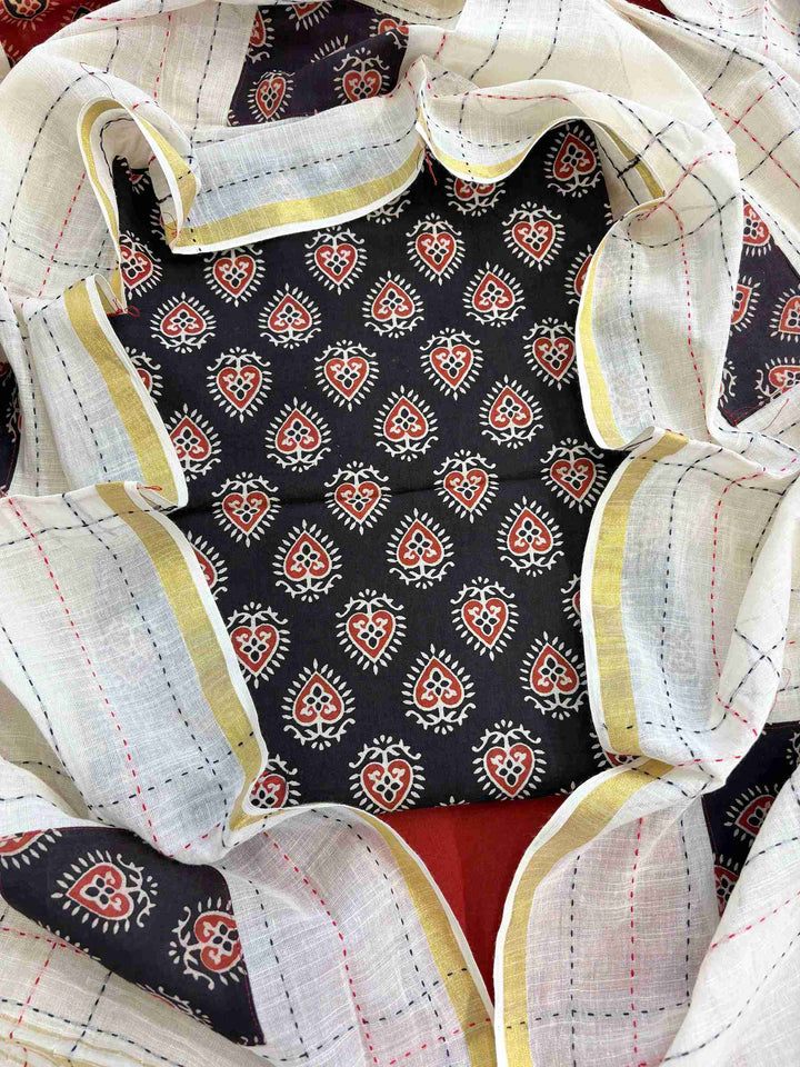 Close-up of black handblock printed cotton kurta fabric with ethnic motifs