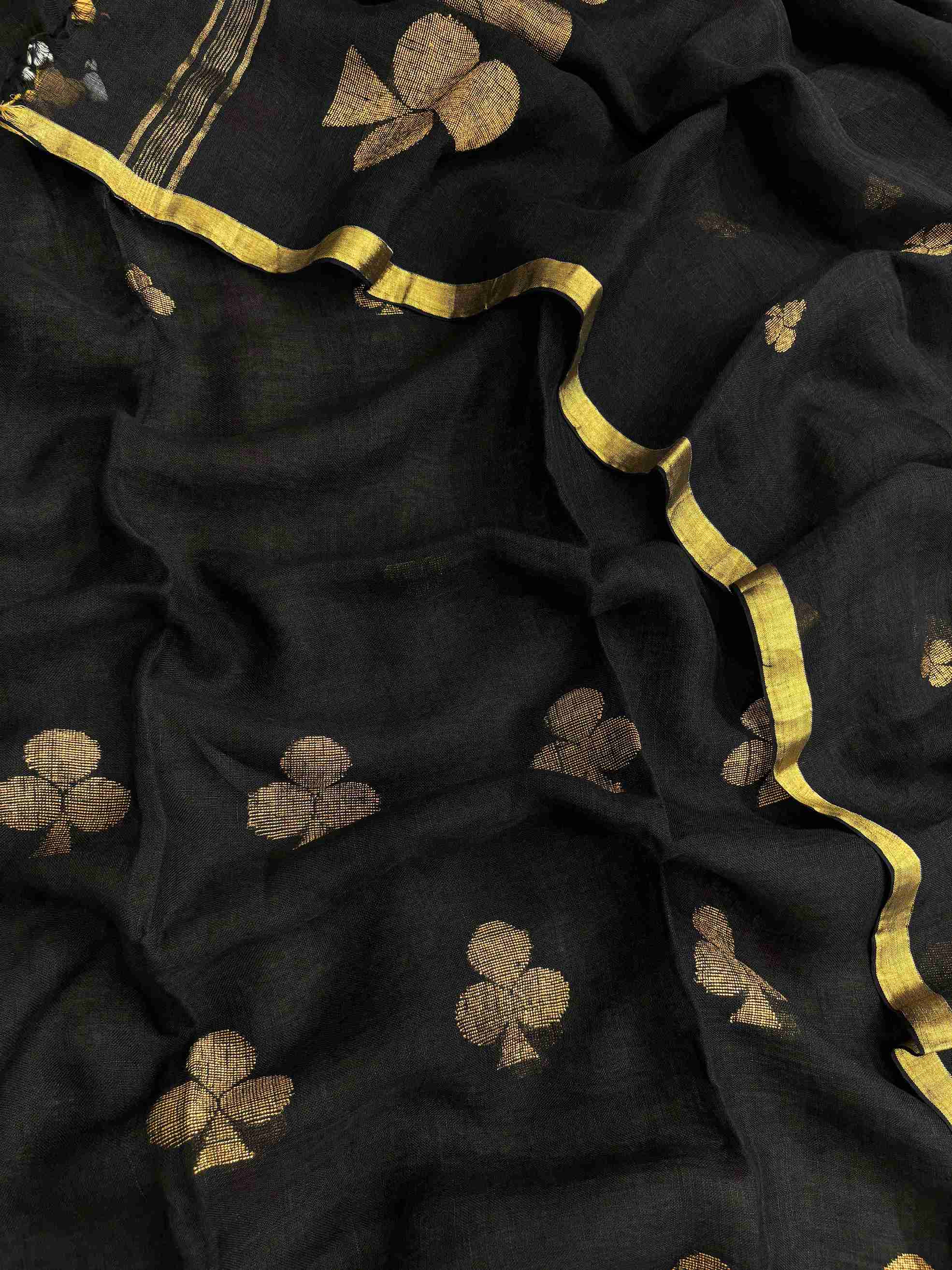 Scattered golden geometric spade woven motifs across black pure handloom linen dupatta surface
