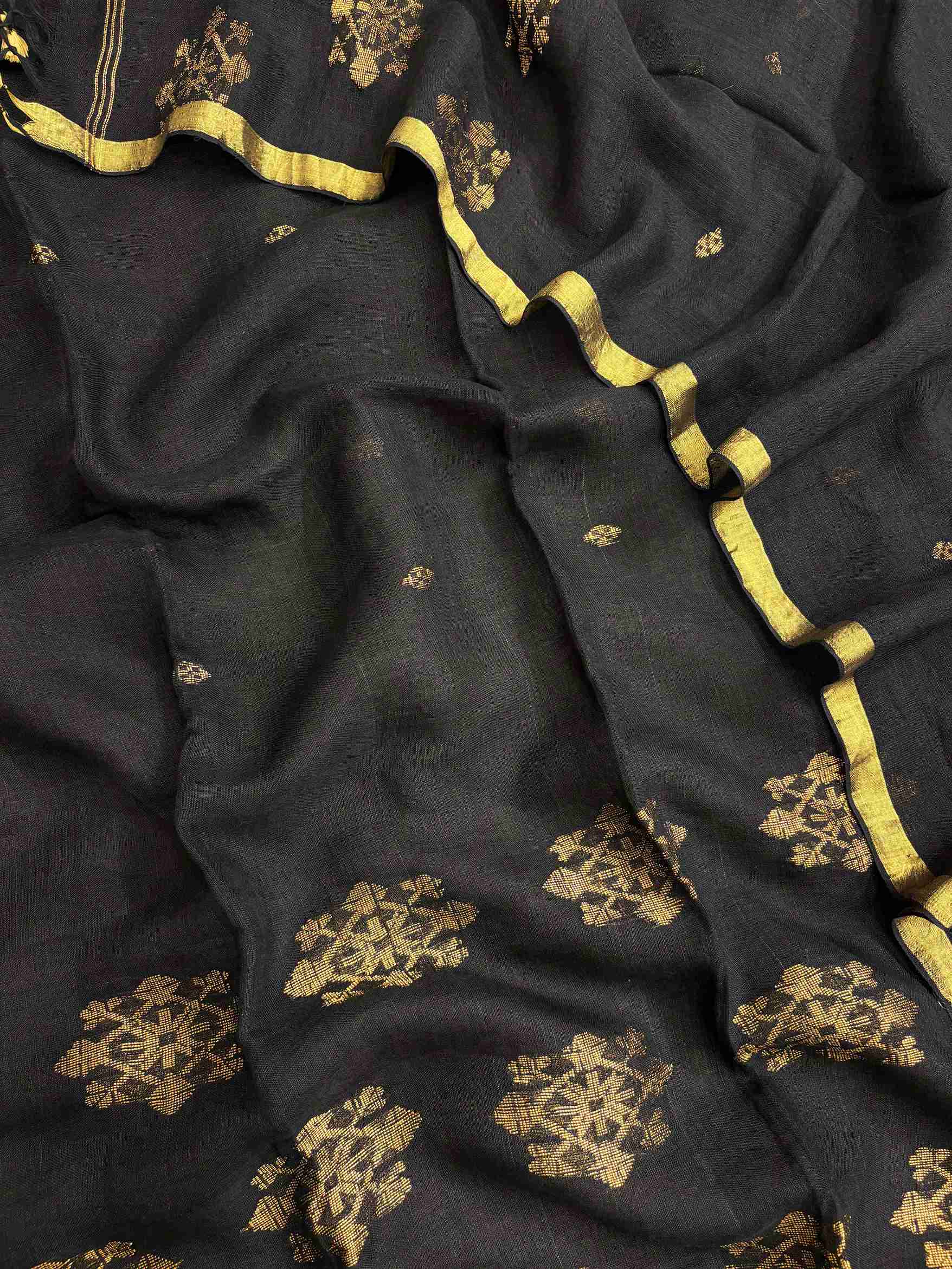 Scattered golden woven floral cluster motifs across black pure handloom linen dupatta surface
