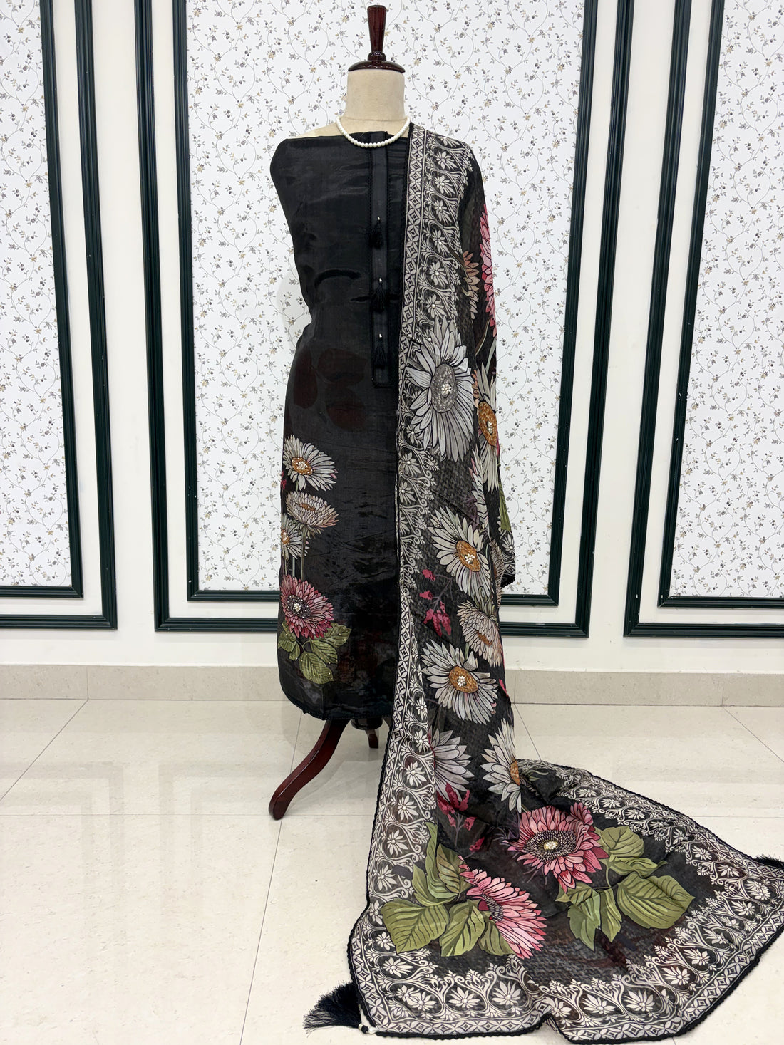 Black silk organza unstitched suit full front view with matching printed dupatta draped on mannequin