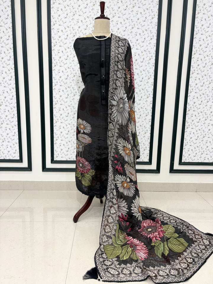 Black silk organza unstitched suit full front view with matching printed dupatta draped on mannequin