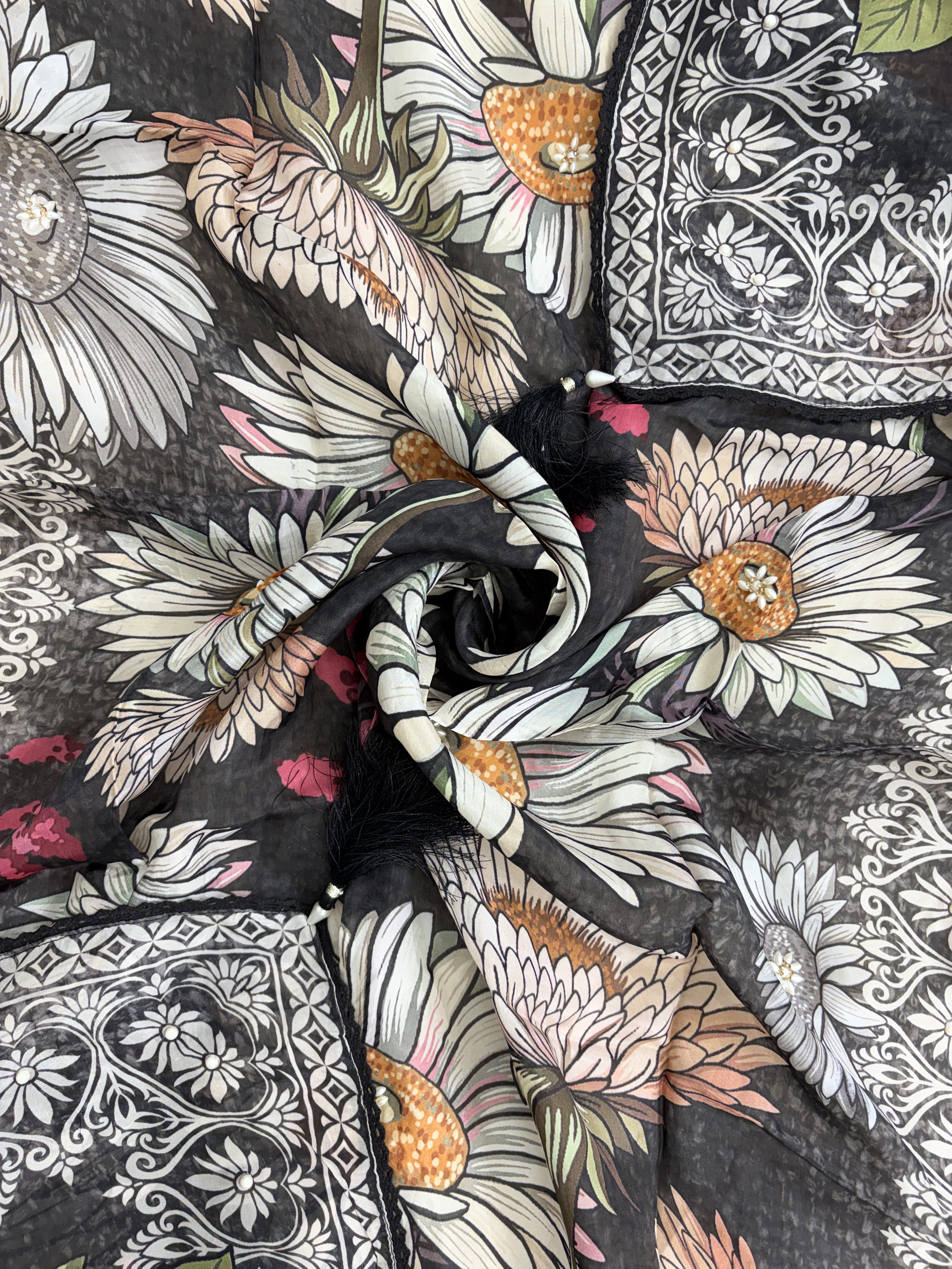 Multicolor digital sunflower print detail across black silk organza dupatta surface