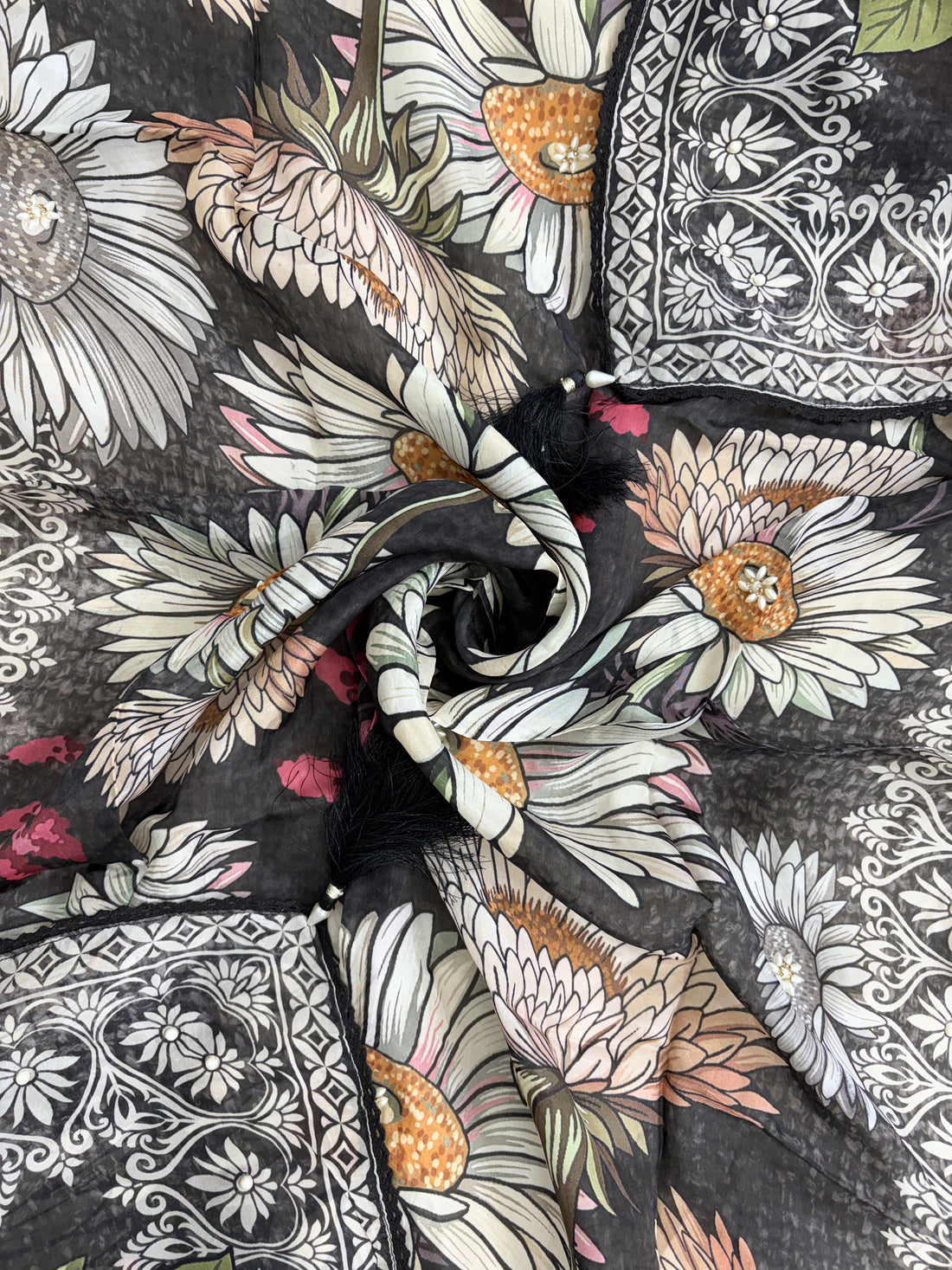 Multicolor digital sunflower print detail across black silk organza dupatta surface