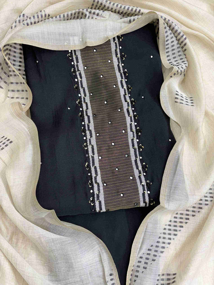 Close view of black viscose shirt featuring mirror highlight detailing on neckline