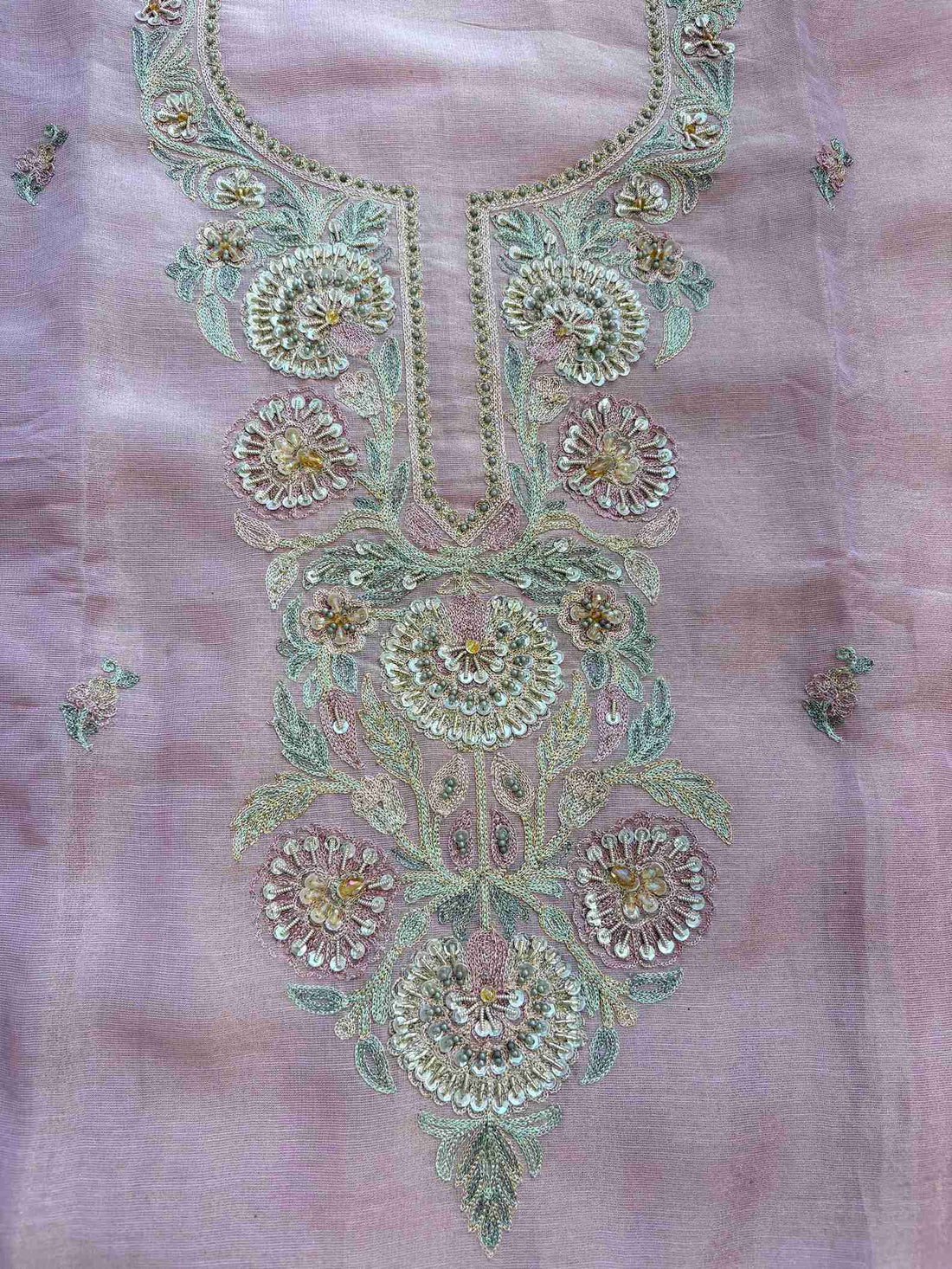 Flat lay of close-up of multicolor resham and zari embroidered neckline with sequins