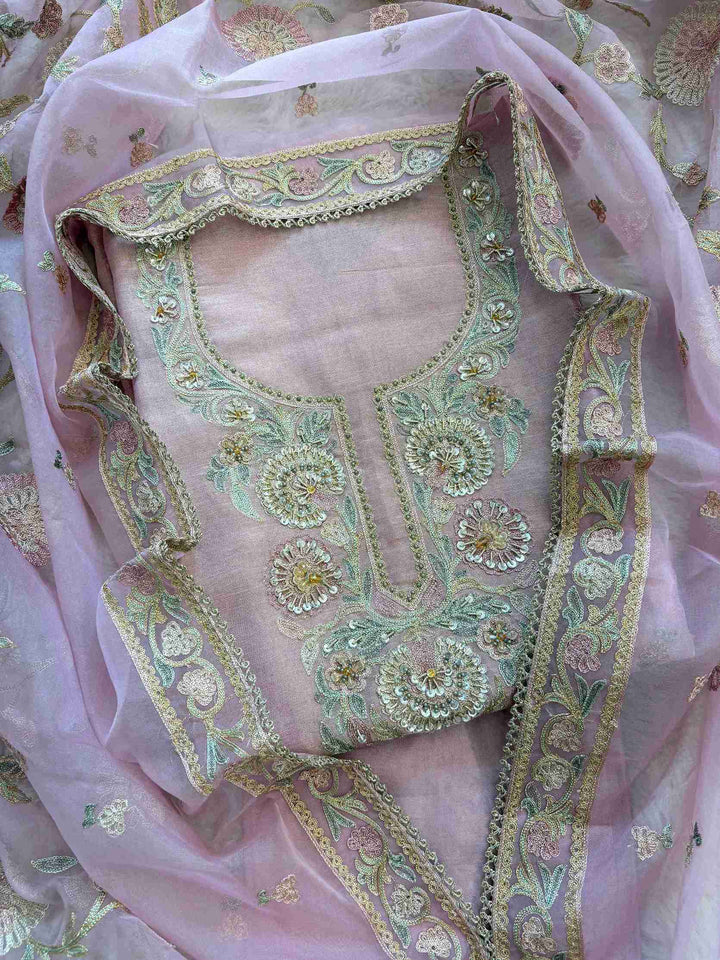 Blush pink shimmer tissue shirt with embroidered neckline and scattered booties