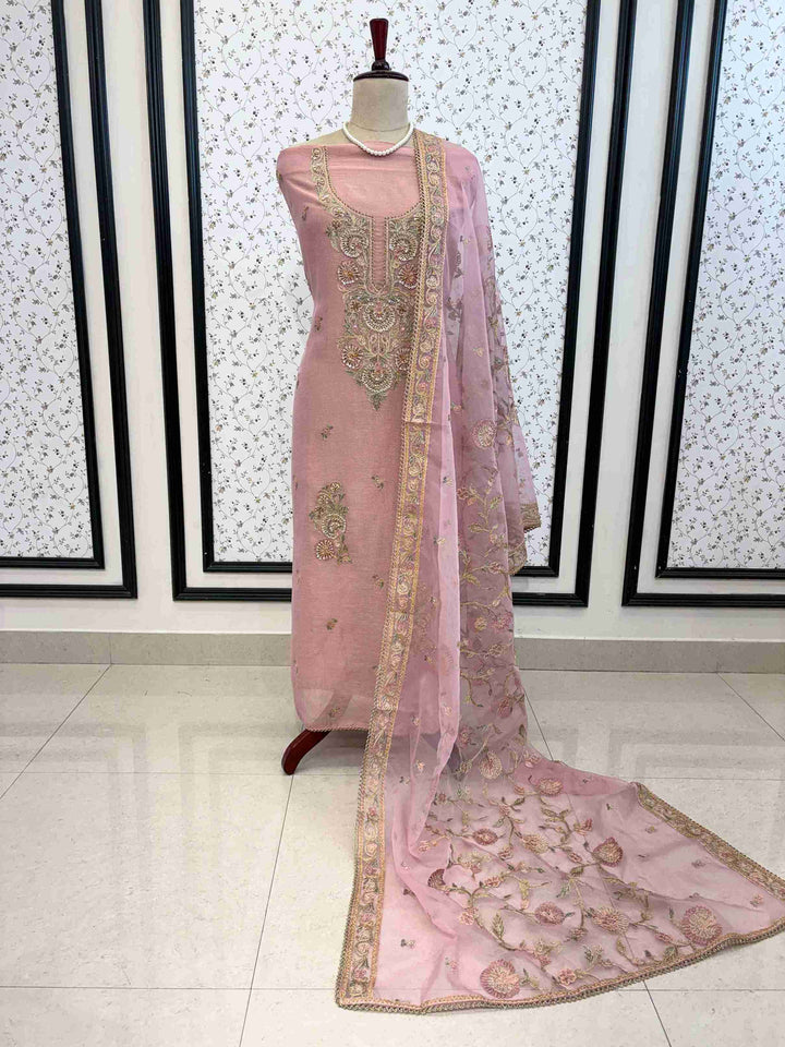 Complete blush pink unstitched suit set with shirt, dupatta, and bottom on manequinn