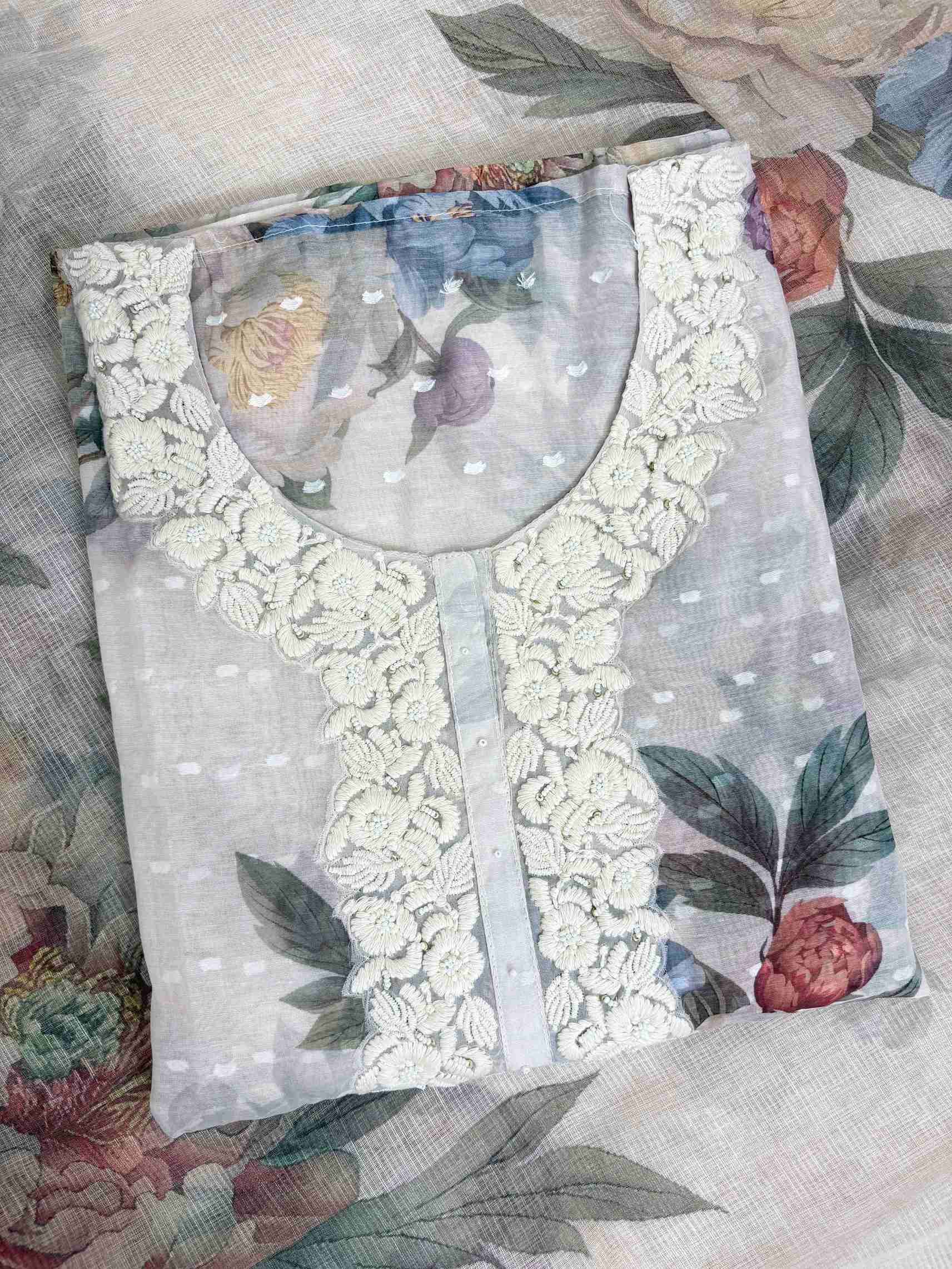 White thread embroidered floral neckline motifs on blush white linen shirt