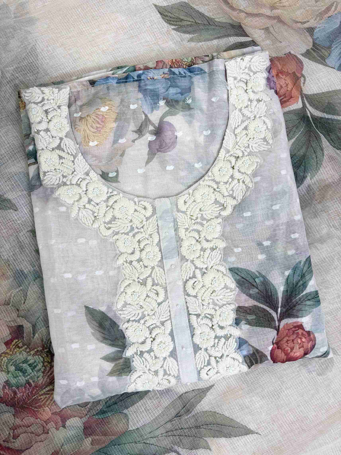 White thread embroidered floral neckline motifs on blush white linen shirt