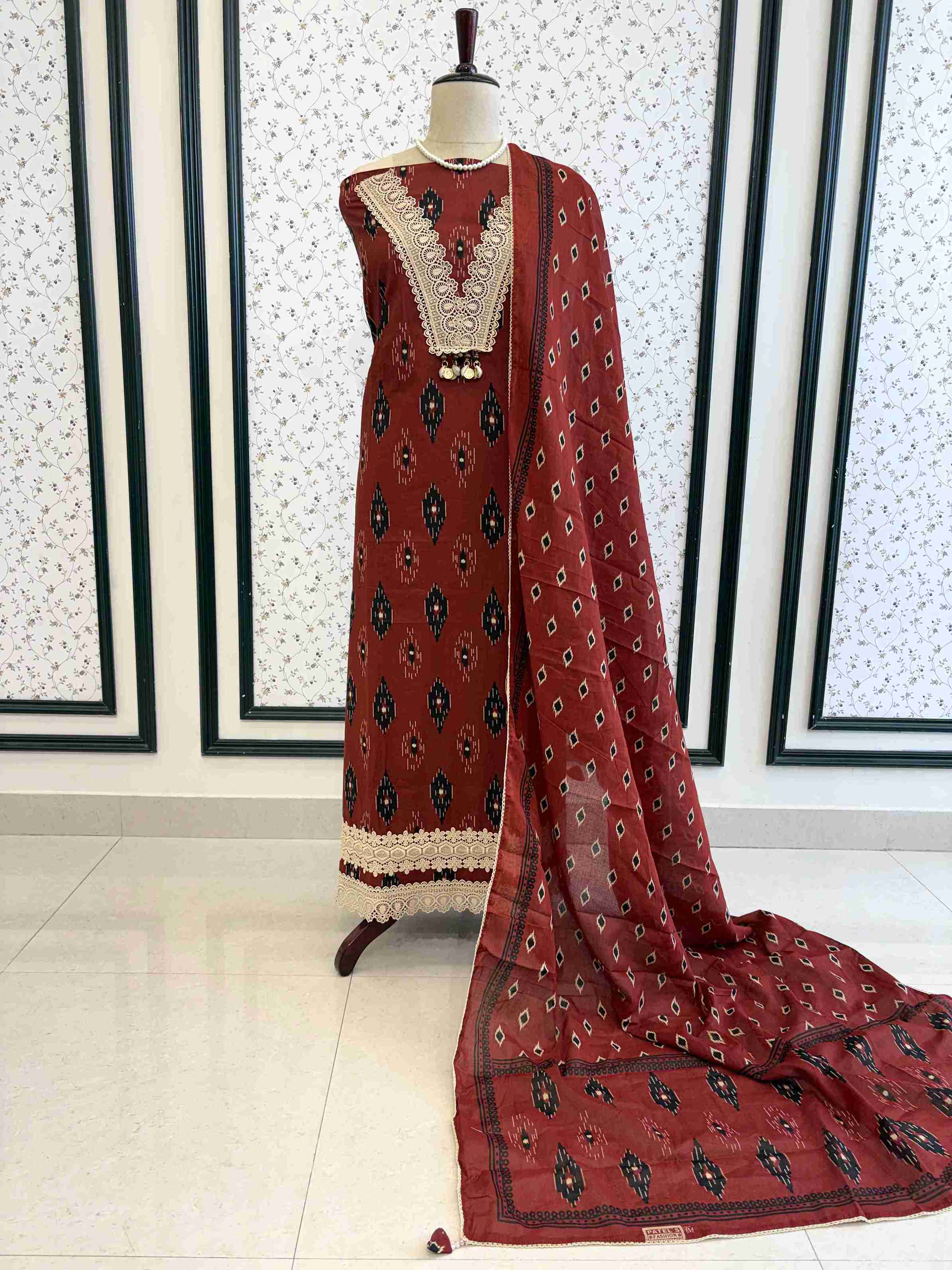 Brick red cotton unstitched suit full front view with matching ikat diamond print dupatta draped on mannequin