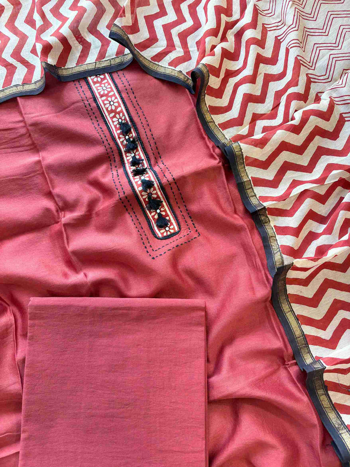 Close-up of printed floral placket neckline on brick red Maheshwari silk suit