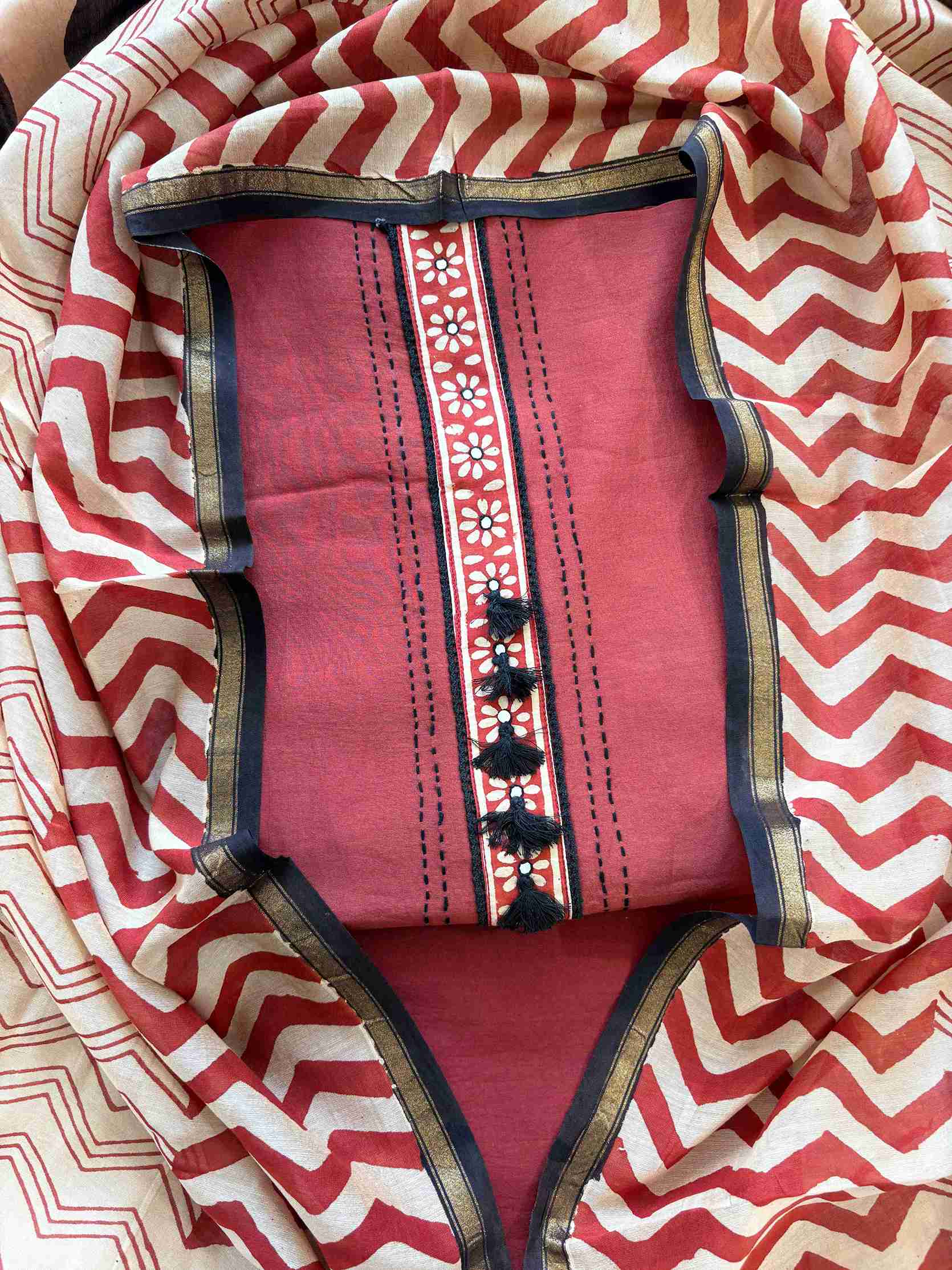 Brick red Maheshwari silk unstitched suit with tassel placket neckline and hand block printed dupatta