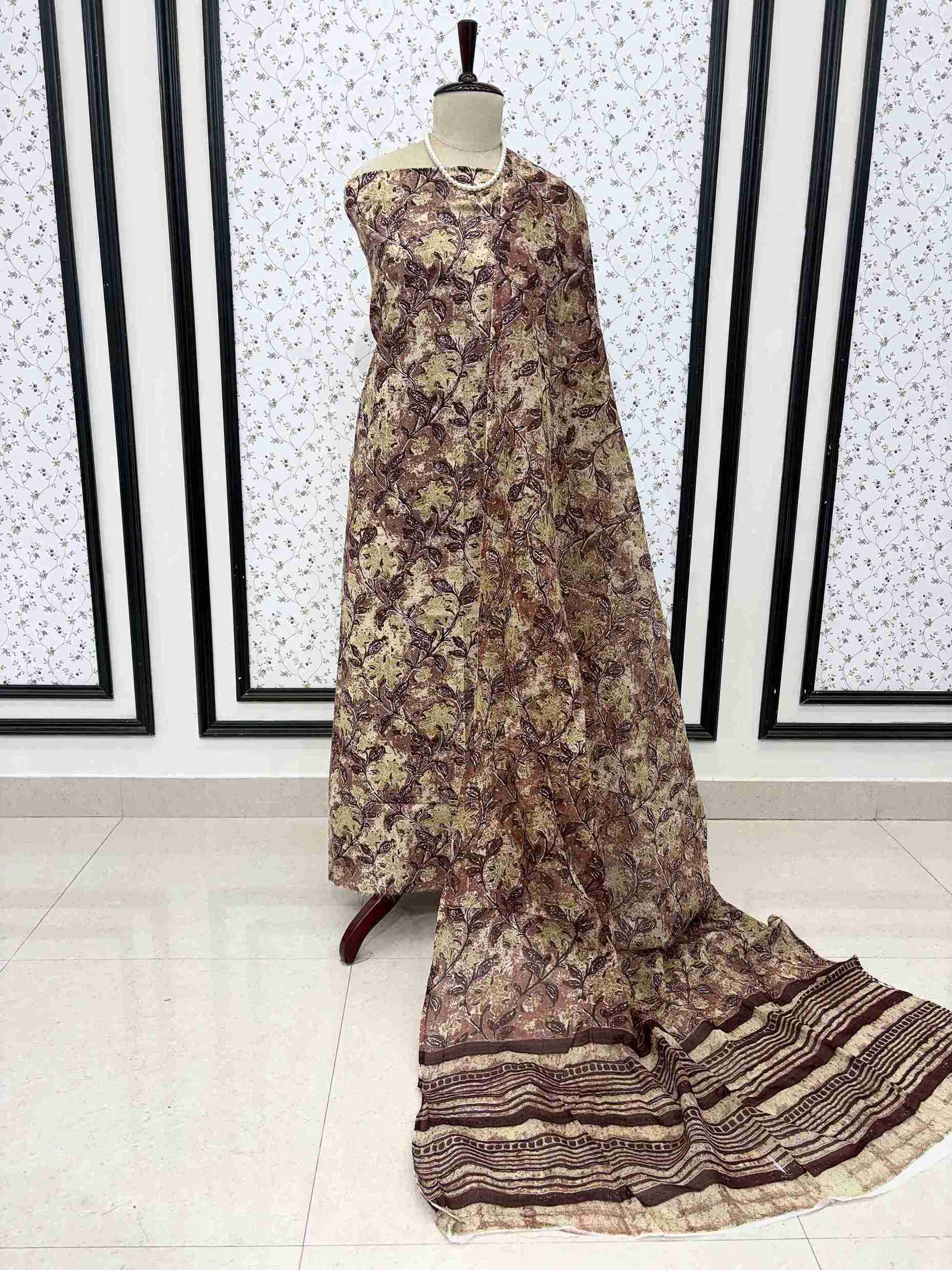 Brown and yellow cotton digital jaal print unstitched suit set displayed on mannequin