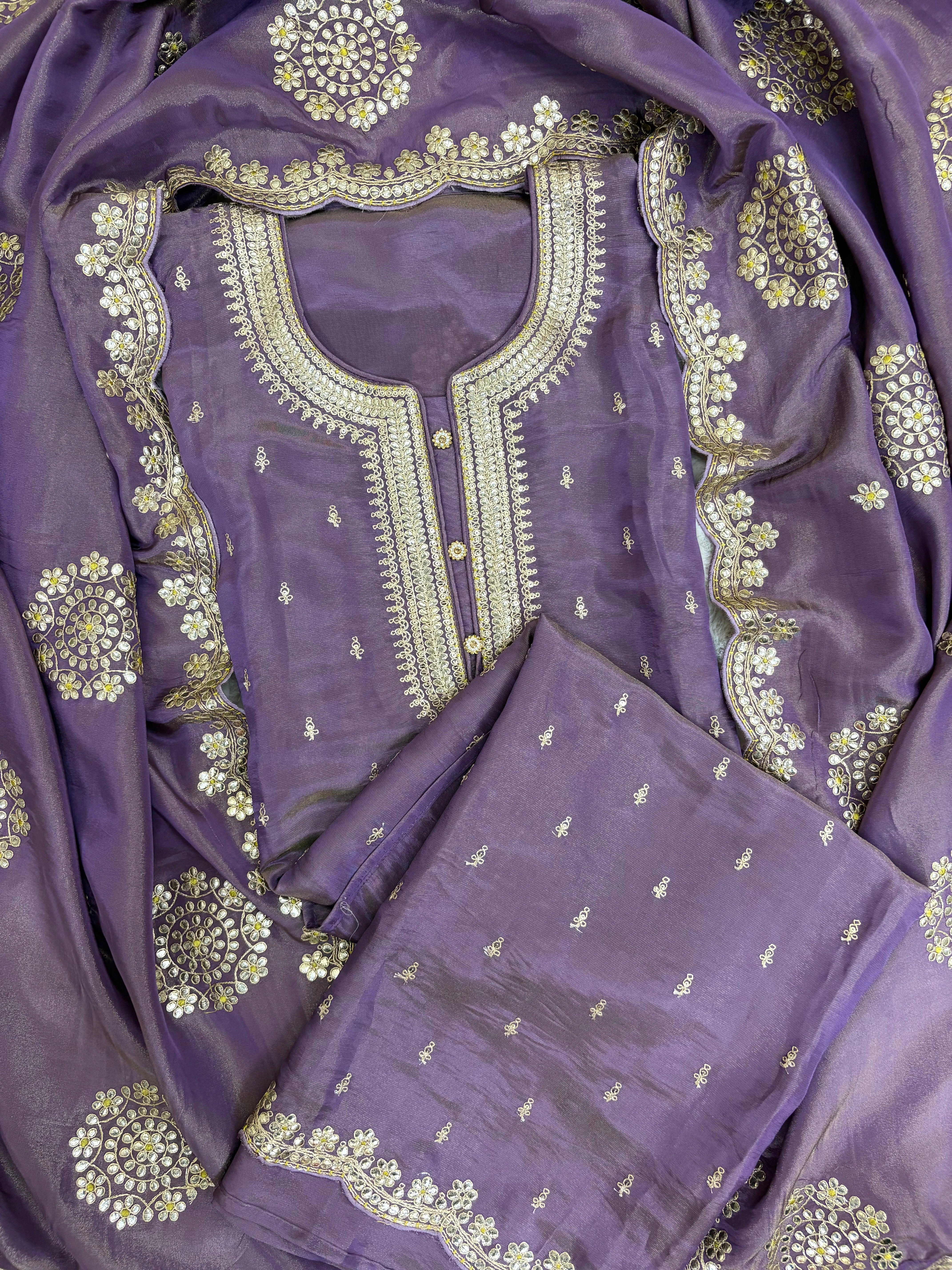 Royal purple silk unstitched suit with golden zari embroidery, sequins, floral motifs, and embroidered dupatta – perfect for weddings and festive wear