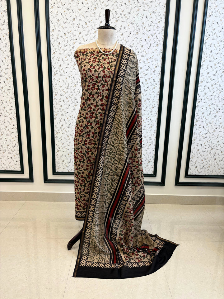Maheshwari fabric suit with Kalamkari floral print in green, ivory, and maroon tones, featuring traditional hand-block designs and striped dupatta.