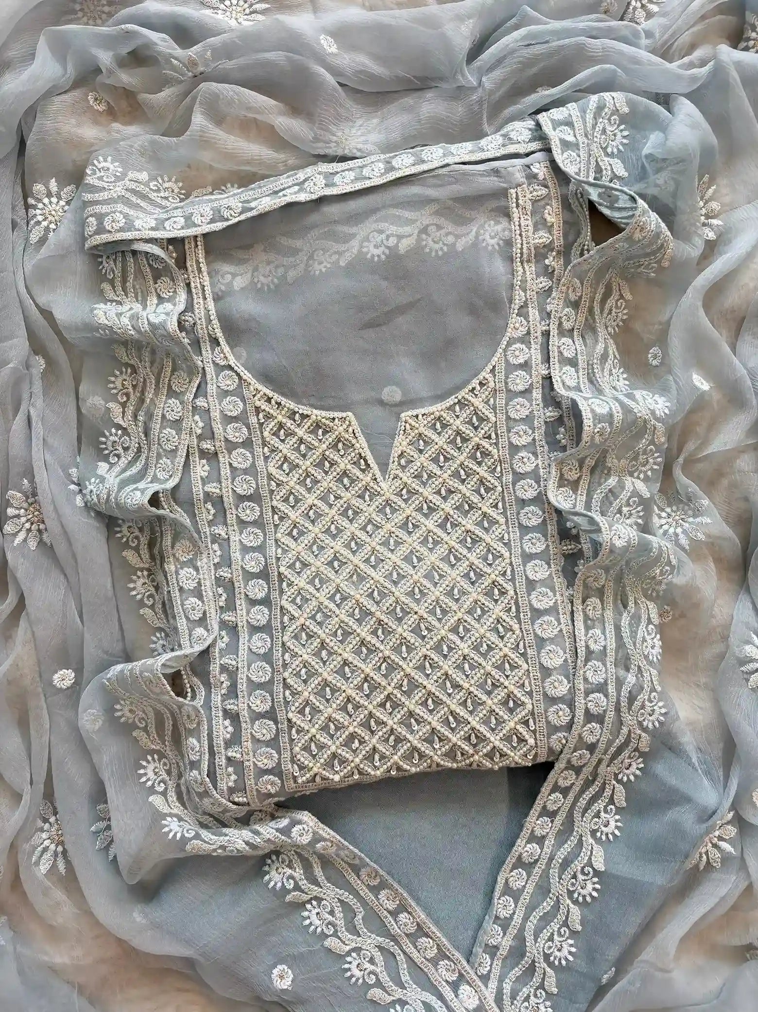 Powder blue georgette suit with moti highlighting and chiffon dupatta – embroidered festive ethnic wear for weddings and formal occasions.