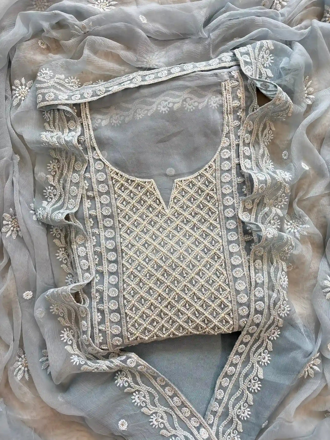 Powder blue georgette suit with moti highlighting and chiffon dupatta – embroidered festive ethnic wear for weddings and formal occasions.