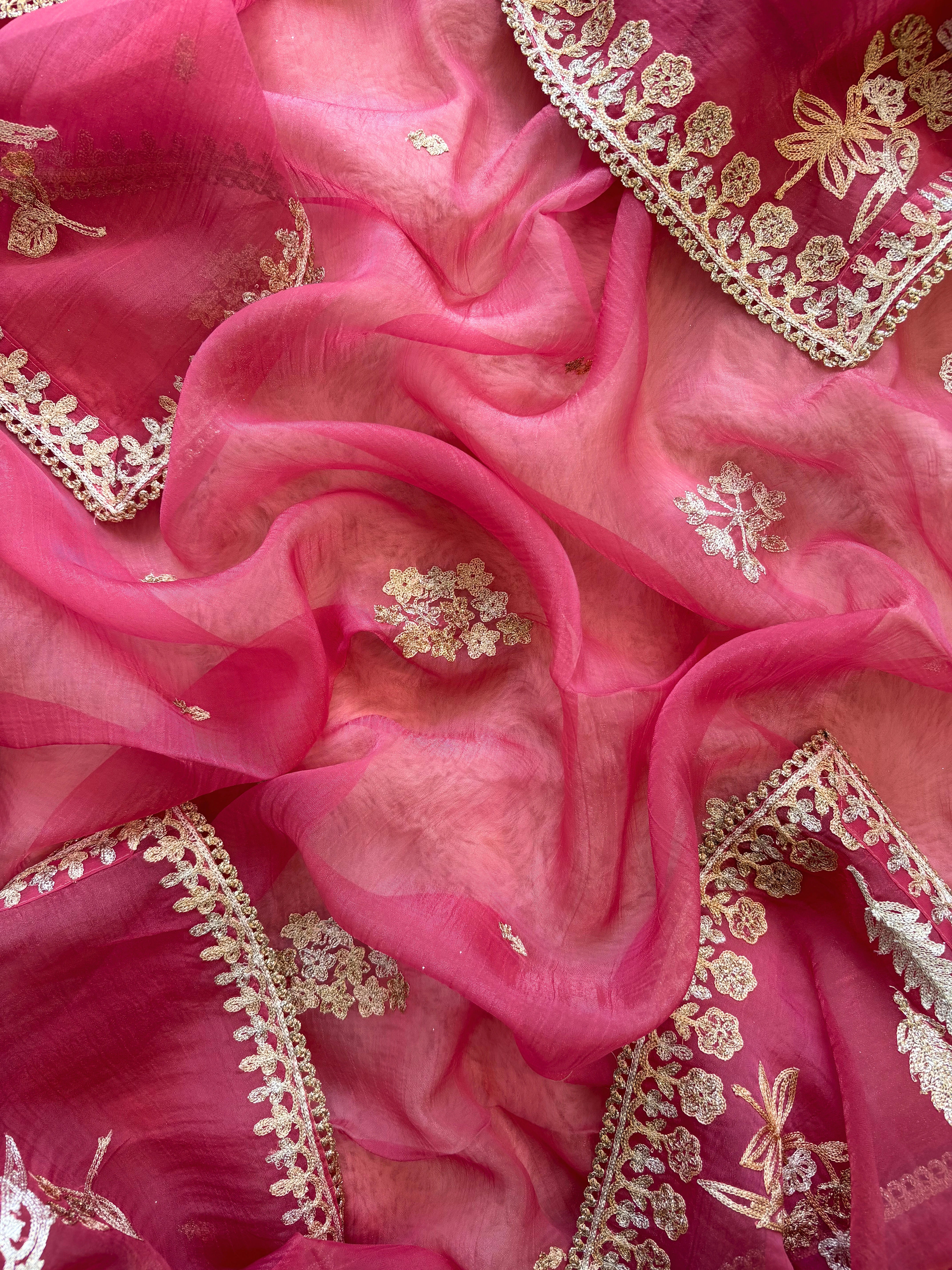 pink organza unstitched suit with zari work and parrot figure