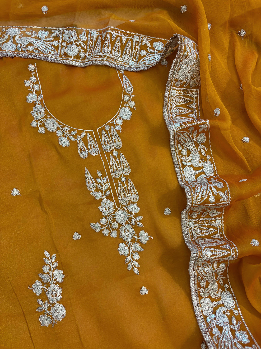 Mustard Yellow organza unstitched suit with golden zari embroidery and embroidered dupatta, ideal for weddings and festive celebrations.