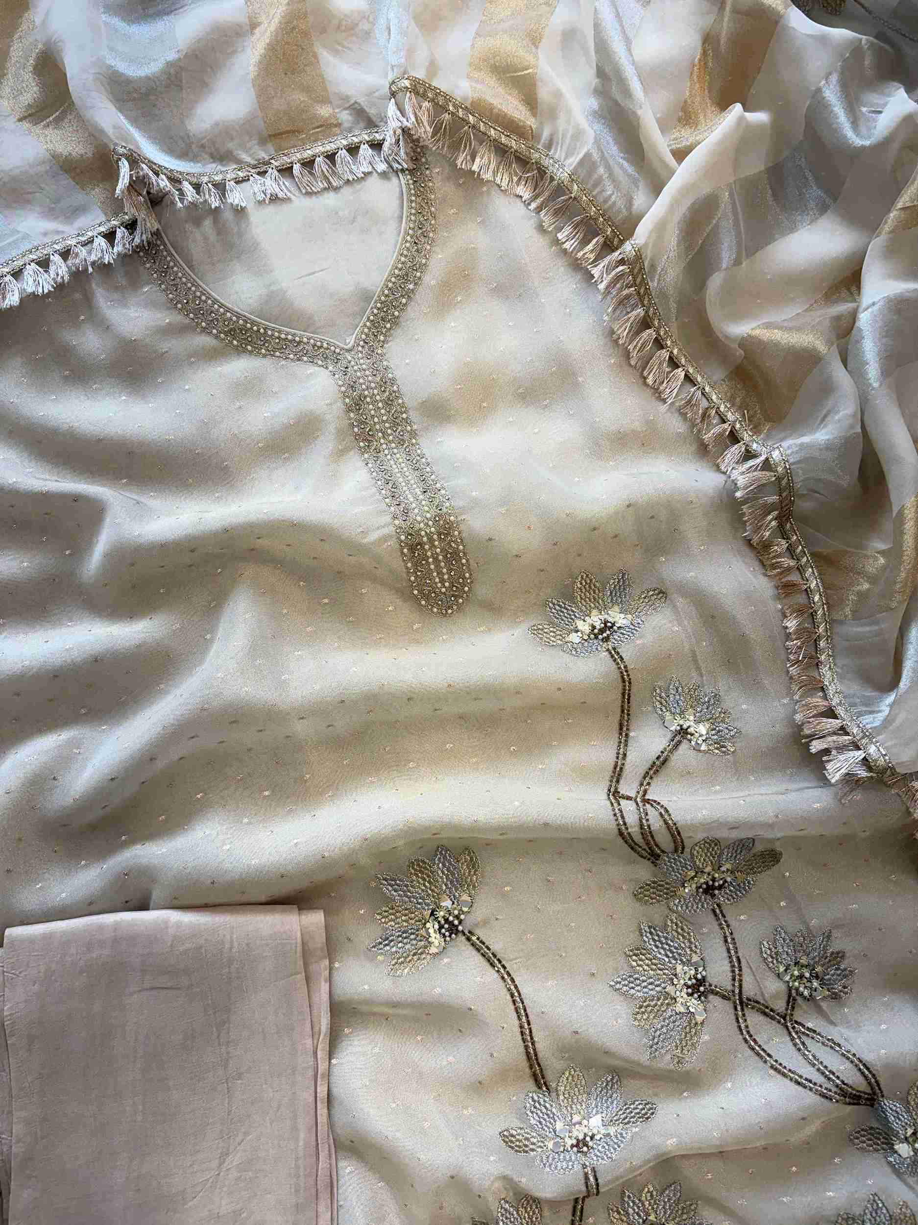 Close-up of neckline on champagne beige shimmer organza unstitched suit