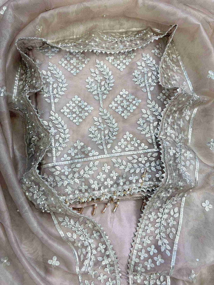 Broad silver gota border at hemline of champagne beige tissue unstitched shirt