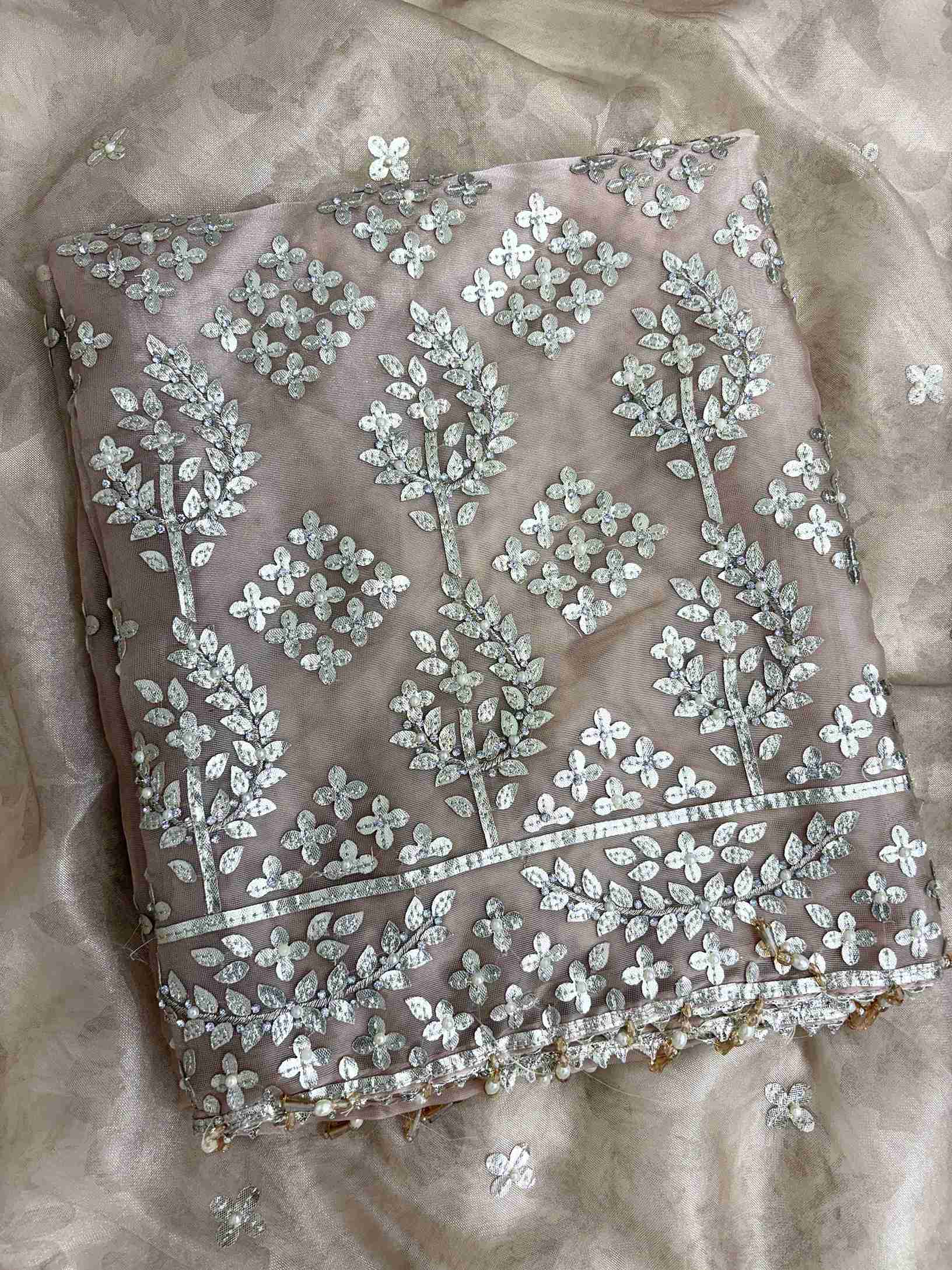 Scattered silver gota motifs across the full body of champagne beige tissue unstitched shirt