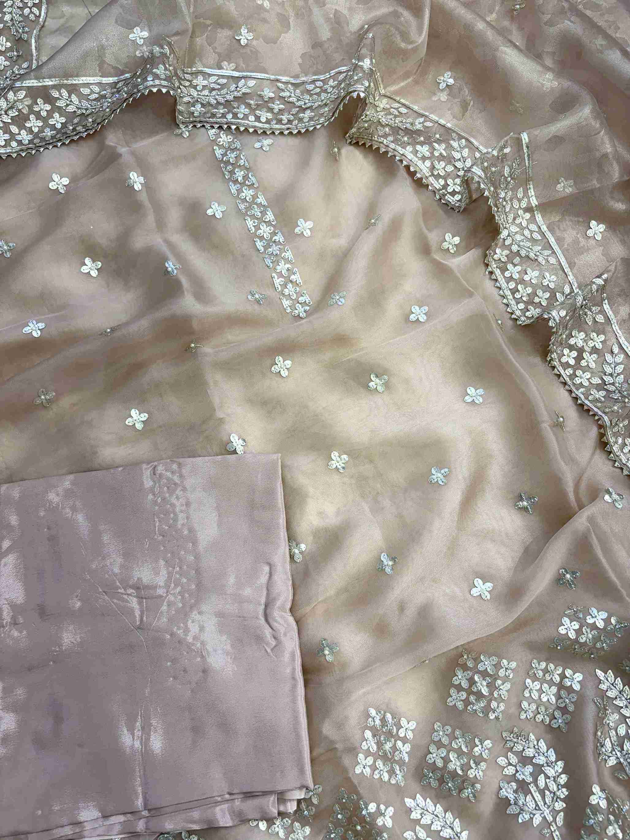 Complete champagne beige tissue unstitched suit flat lay set with shirt, dupatta, and opada silk bottom