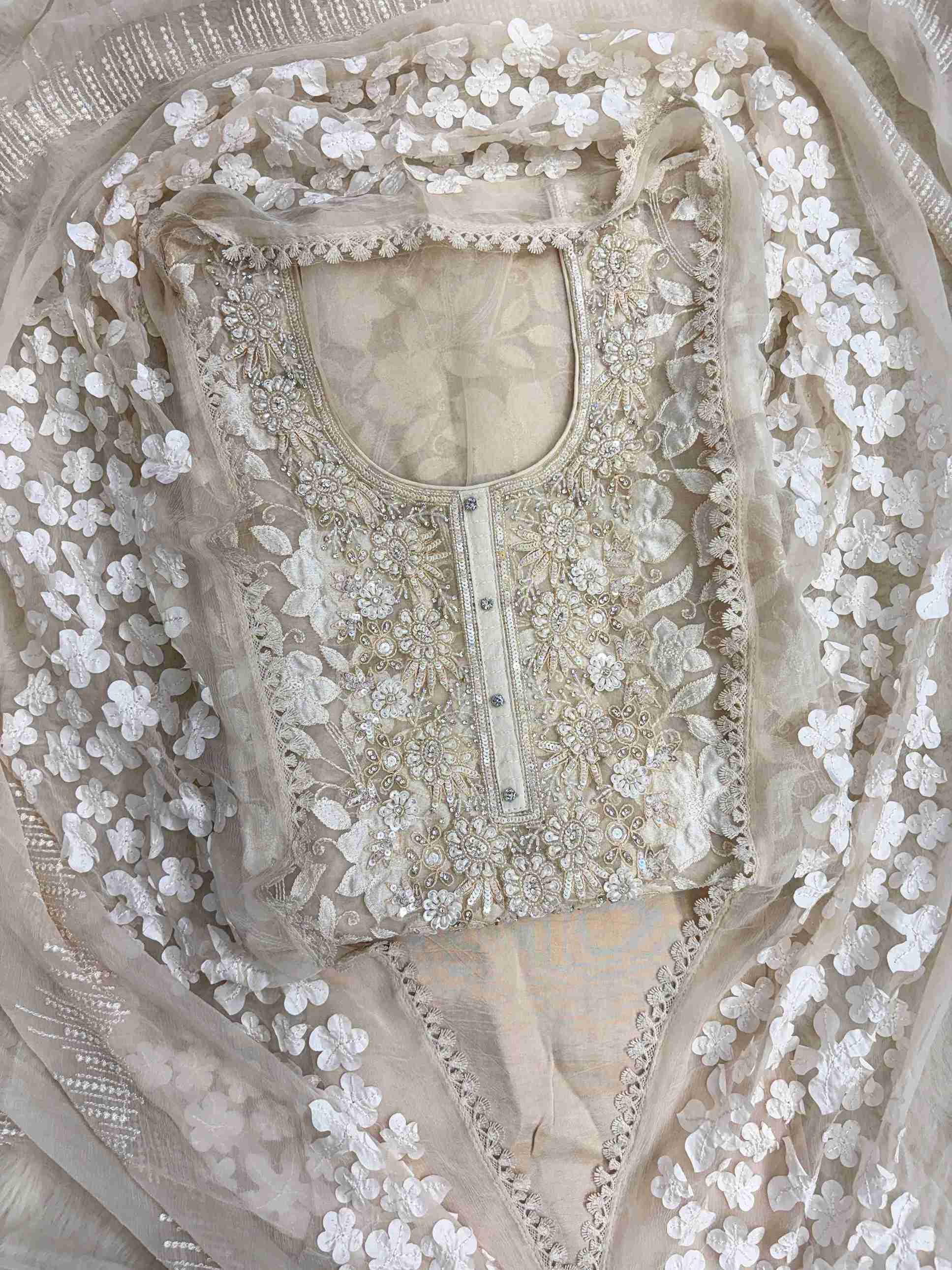 Heavily embellished sequin, moti, and bead neckline detail on champagne organza unstitched shirt