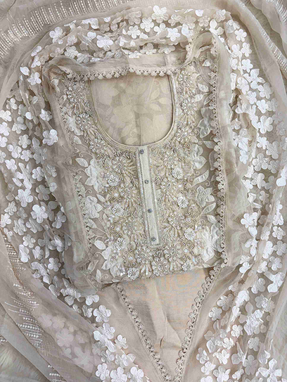 Heavily embellished sequin, moti, and bead neckline detail on champagne organza unstitched shirt