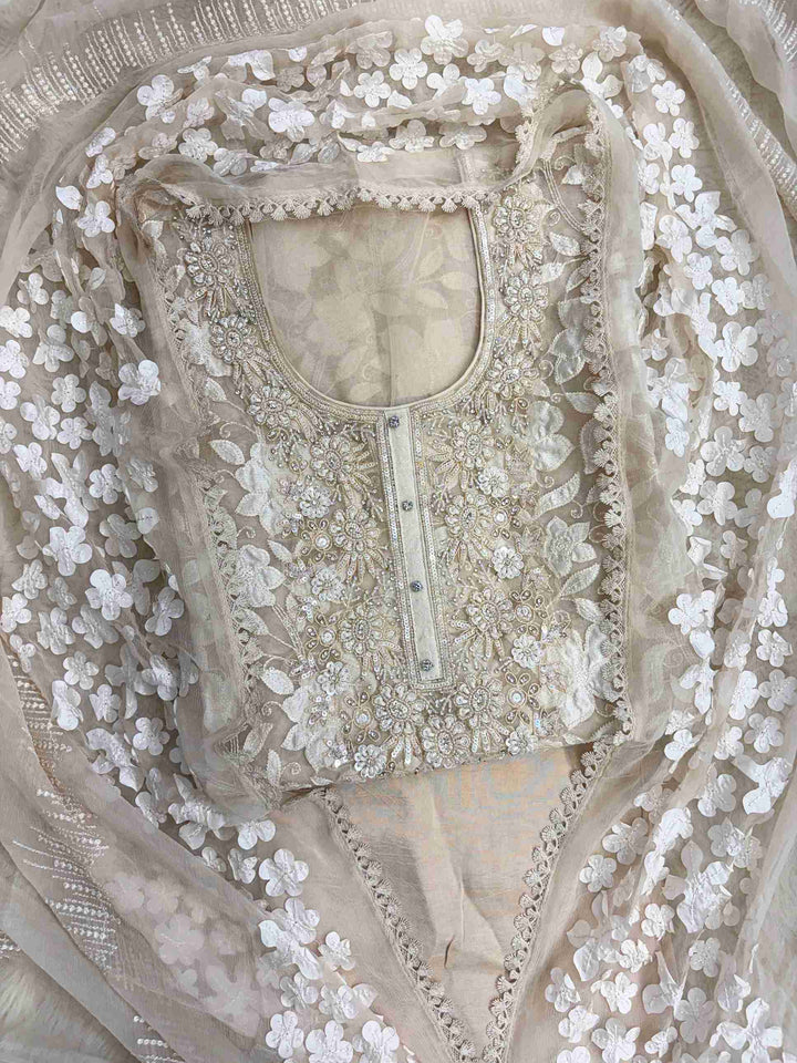 Heavily embellished sequin, moti, and bead neckline detail on champagne organza unstitched shirt