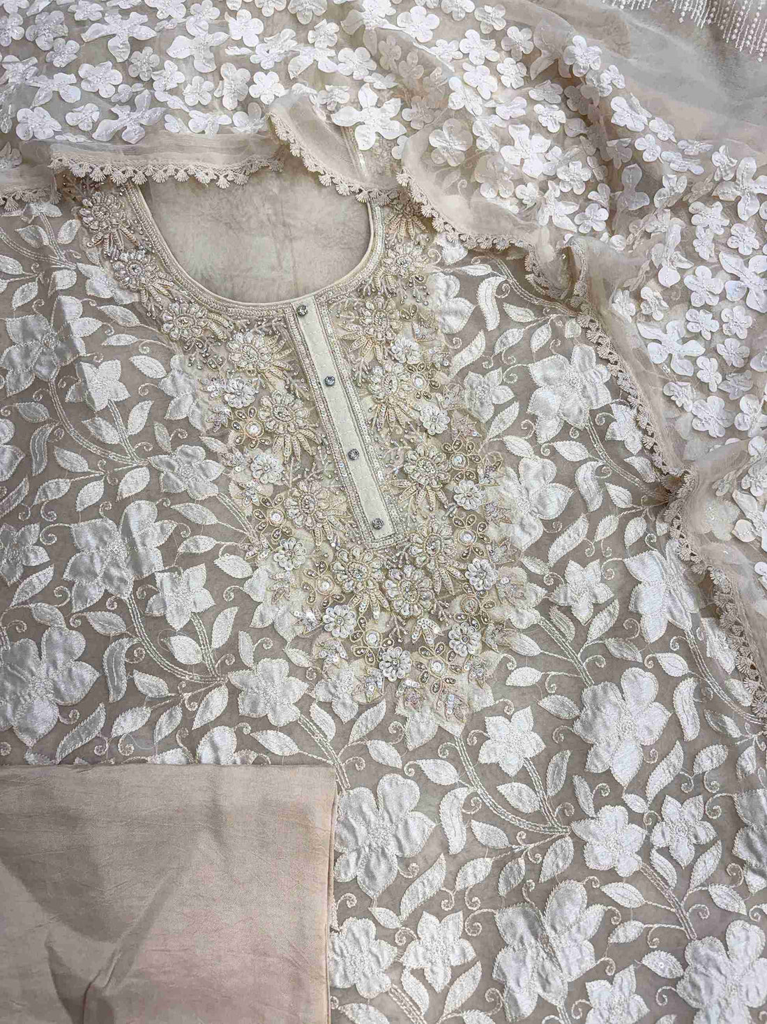 Complete champagne organza unstitched suit flat lay set with shirt, chiffon dupatta, and opada silk bottom