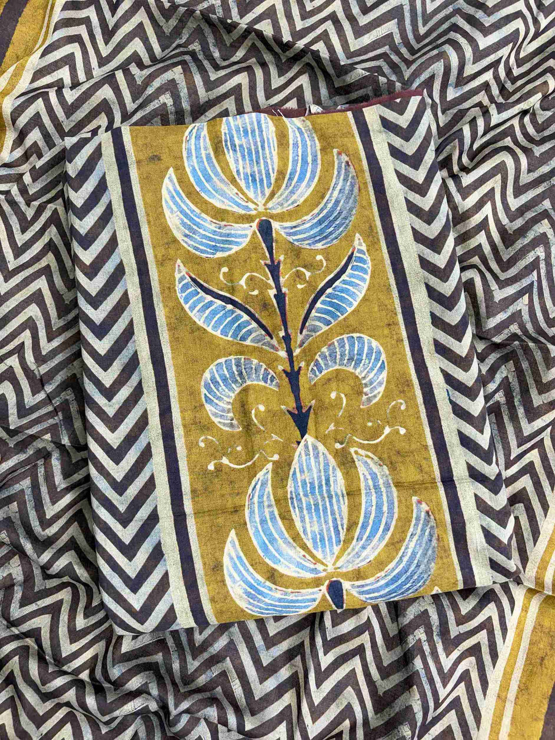 Large olive and blue floral inspired motifs on central front panel of charcoal grey mul cotton shirt