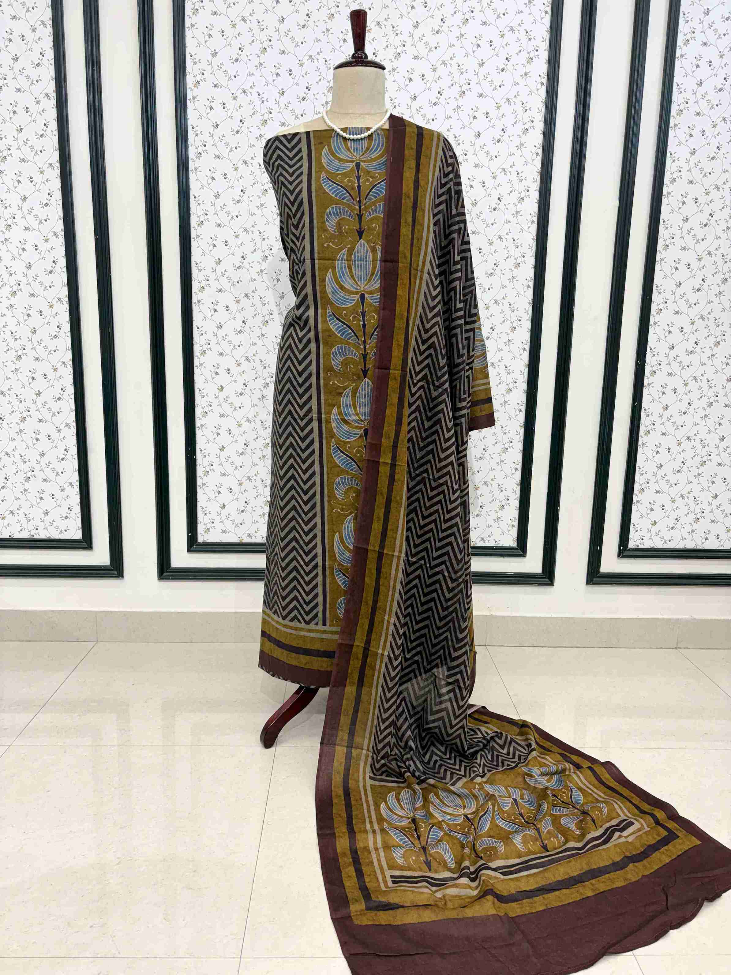 Charcoal grey mul cotton unstitched suit full front view with zigzag and floral motif dupatta draped on mannequin