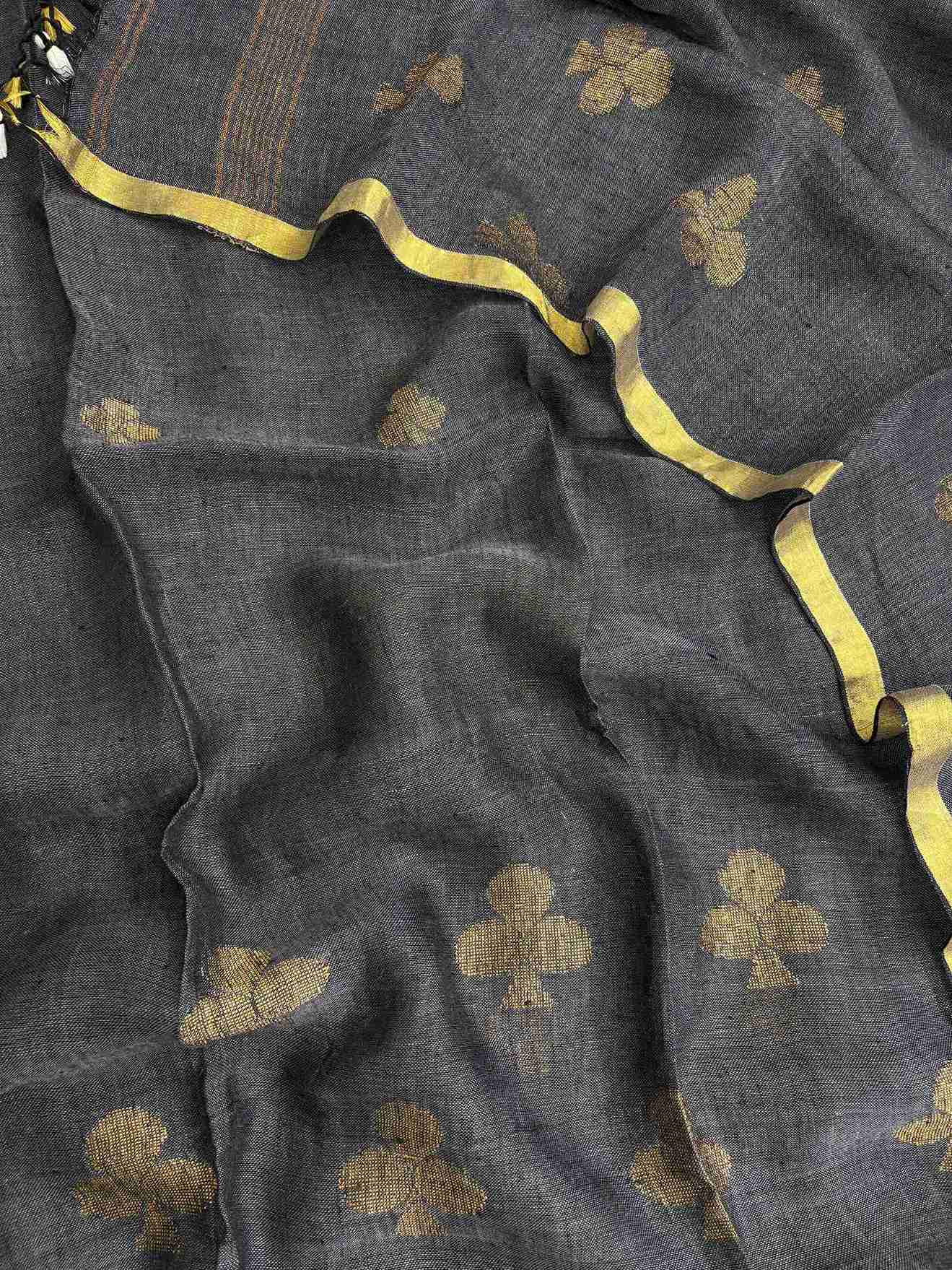 Scattered golden geometric spade woven motifs across charcoal grey pure handloom linen dupatta surface