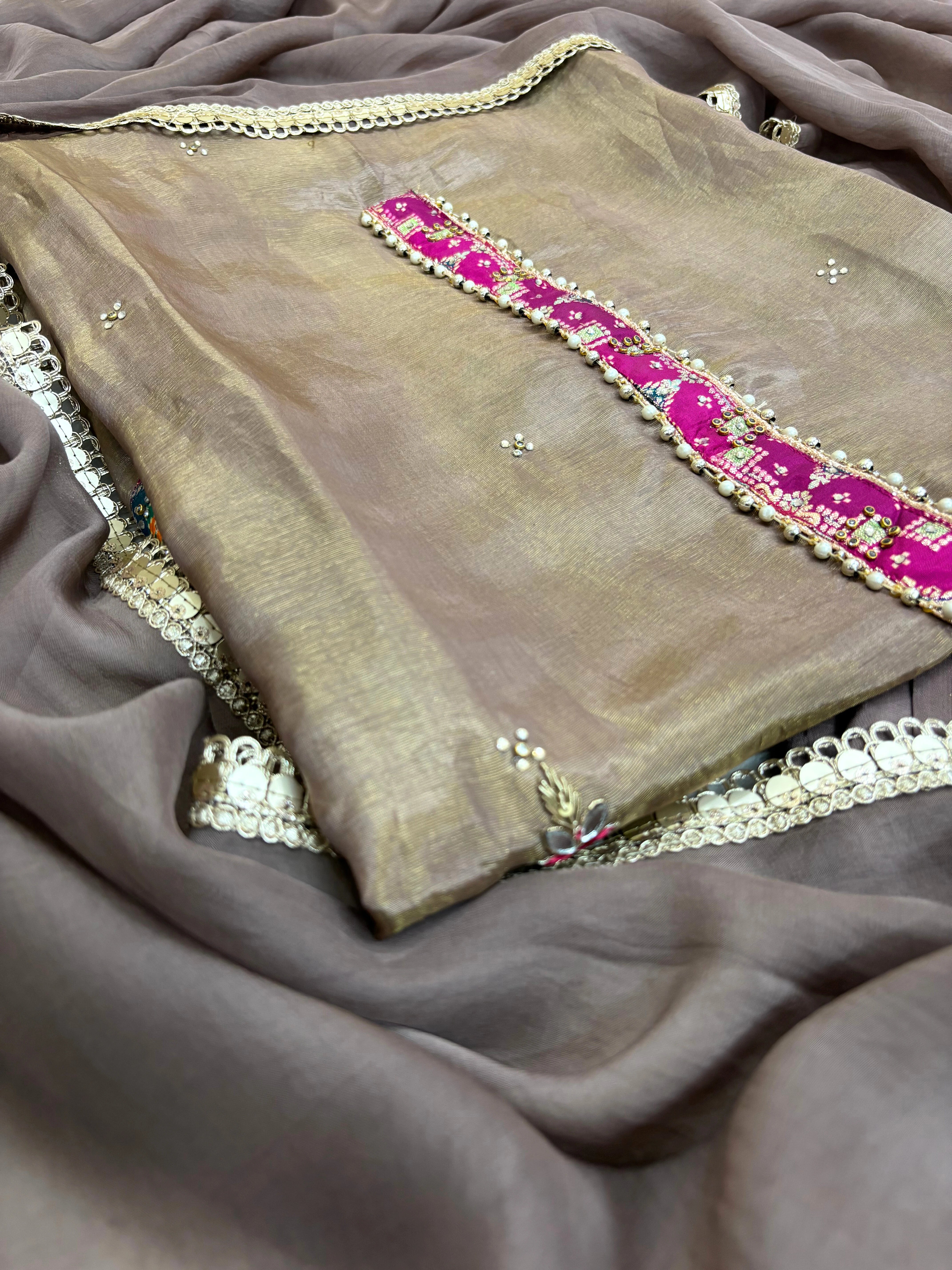 Taupe brown organza unstitched suit with mirror work, sequin embroidery, and magenta contrast neckline patch, paired with mirror lace organza dupatta – festive ethnic wear